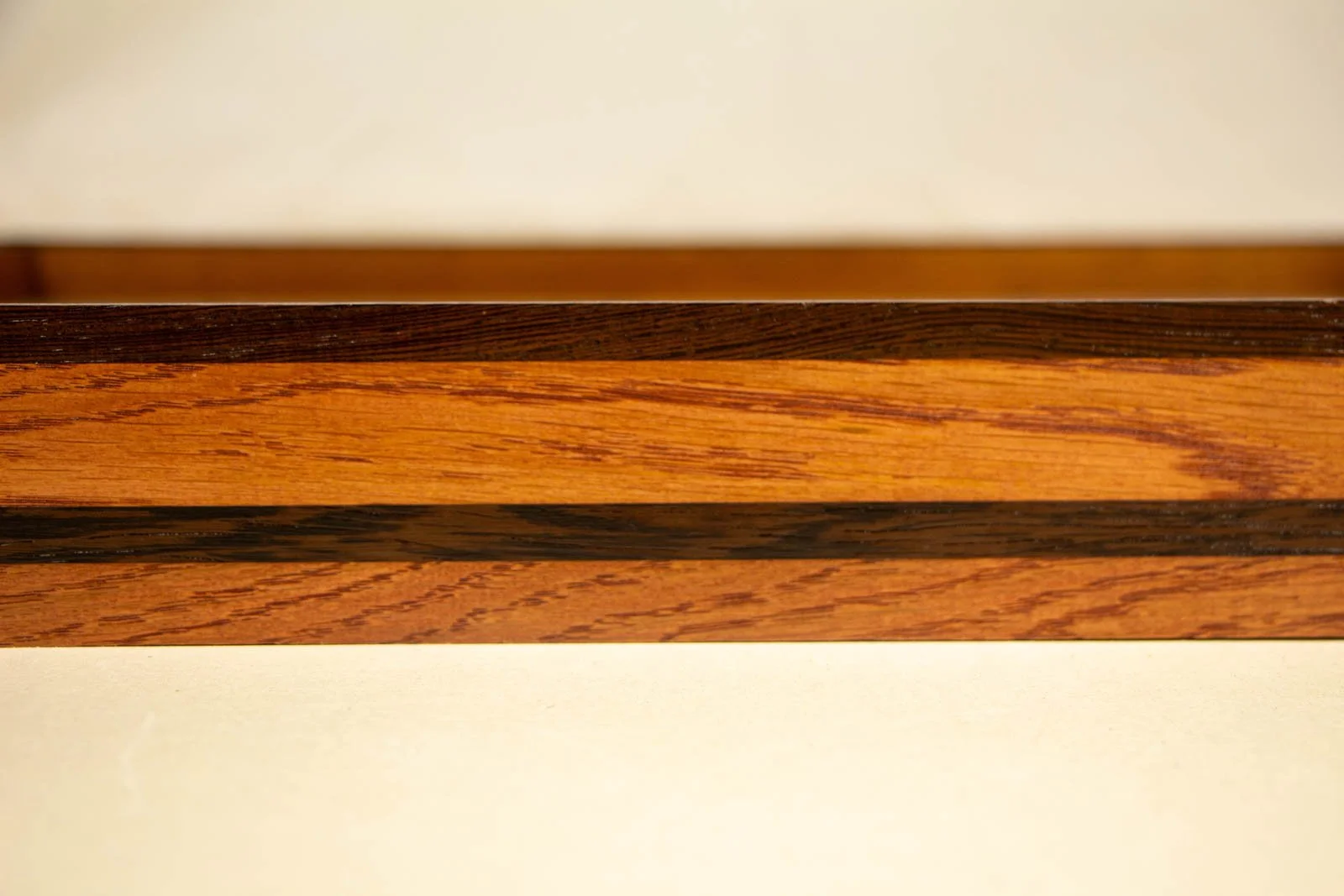 Metamorphic Entwining 001 frame: side view showing cherry body, continuous wengé stripe, and slim wengé lip