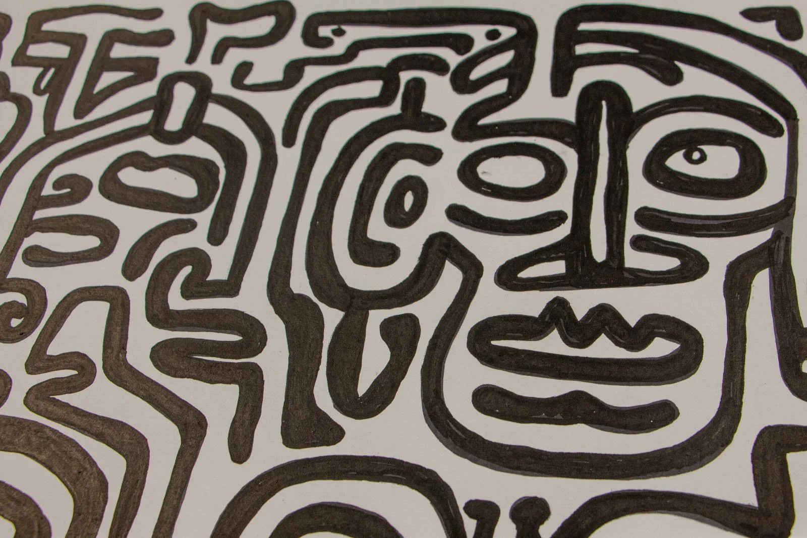Formless Equation 002 detail: paired oval eyes and small mouth shapes among sweeping curves, ink on paper