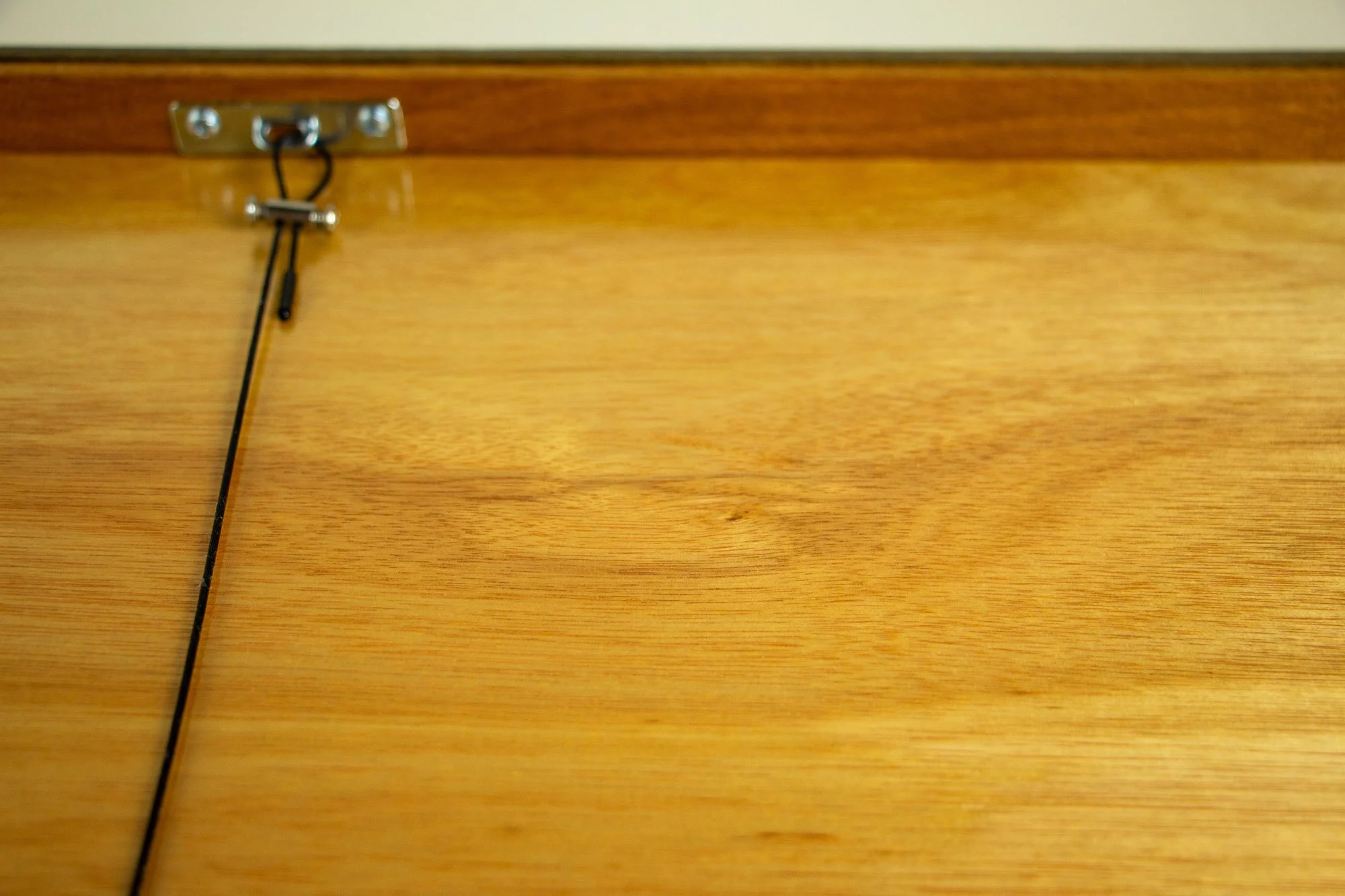 Unseen Signifiers 007 frame detail: back view of the framed work, showing the smooth wooden back panel and the hanging cable anchored along the upper edge