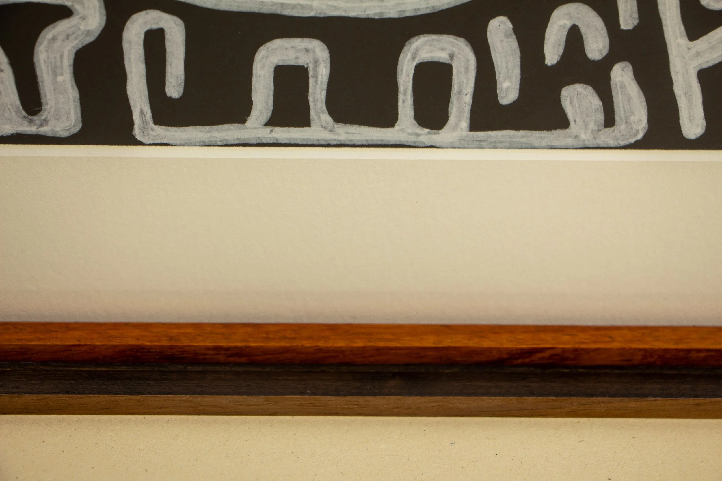 Mêlée of Discovery 001 frame: bottom-edge detail of the framed work, contrasting the cream mount, warm inner lip, and darker outer structure in a calm horizontal sequence.