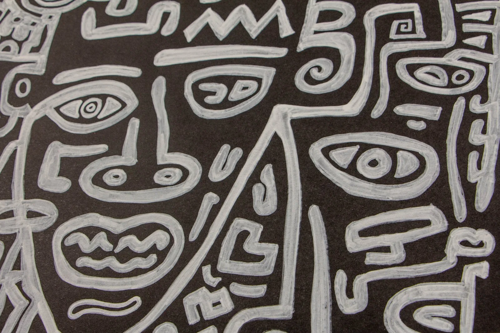 Metamorphic Entwining 004 detail: tight cluster of eye-motifs and a zig-zag “crown”; a dividing contour splits two profiles; layered white on matte black with soft grey halos from double passes