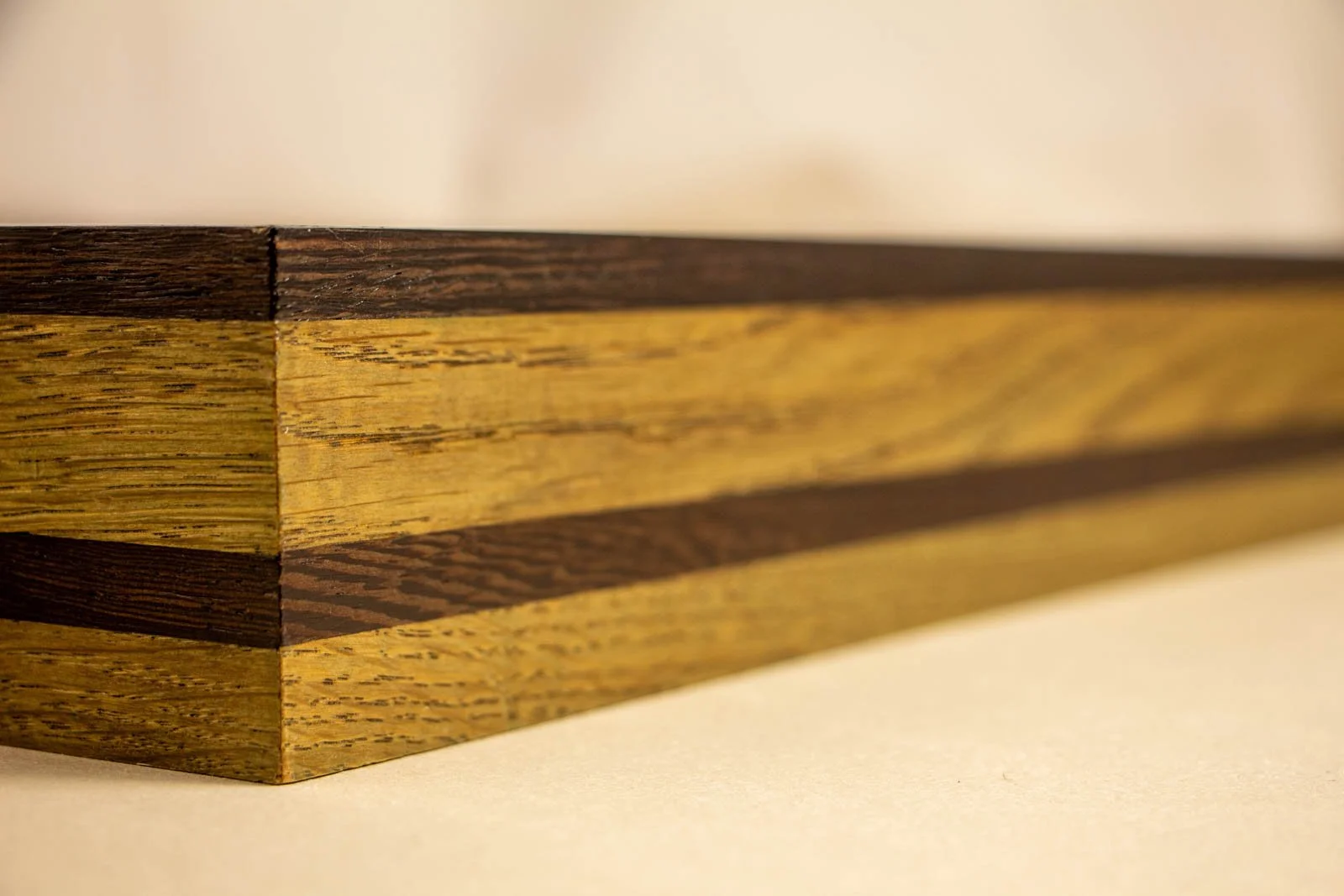 Formless Equation 002 frame: mitred corner showing twin wengé bands in oak, precise joinery