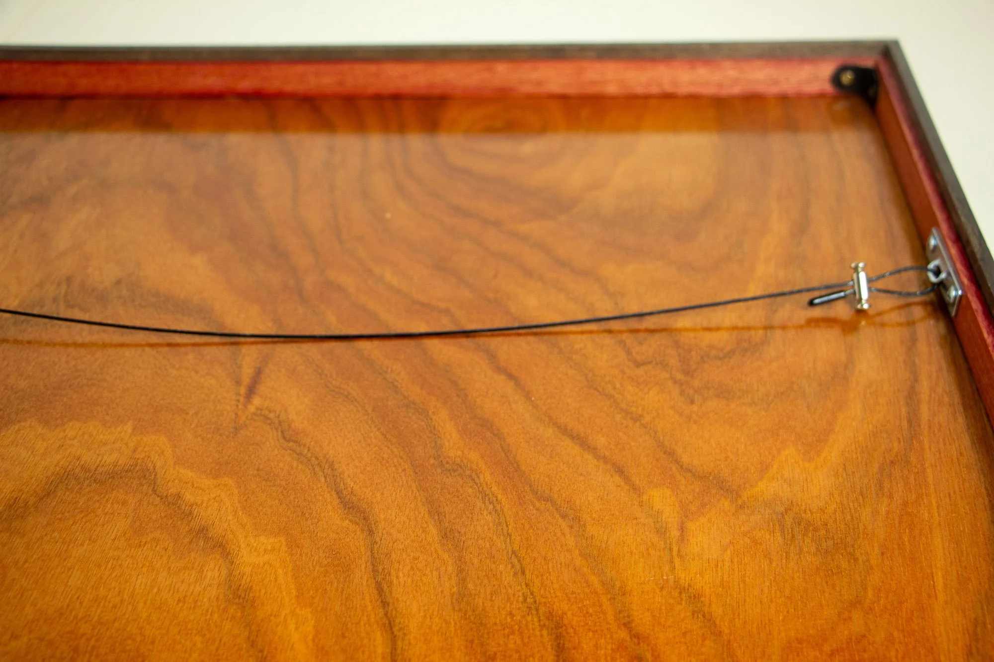 Luminous Parallax 002 frame: reverse view of the framed work, showing the meranti plywood back panel, the hanging wire system, and the clean rear construction of the piece.