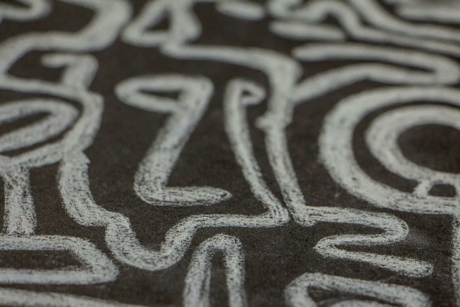 Synaptic Mythos 004 detail: stacked glyphs, nested loops and tapered marks; tonal variation across the charcoal ground