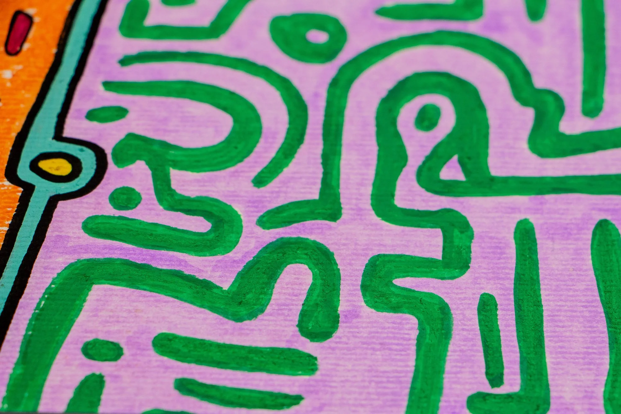 Unseen Signifiers 002 detail: close-up of the lilac background patterned with green signs, meeting the black-edged turquoise and orange contours of the figure at the left edge.