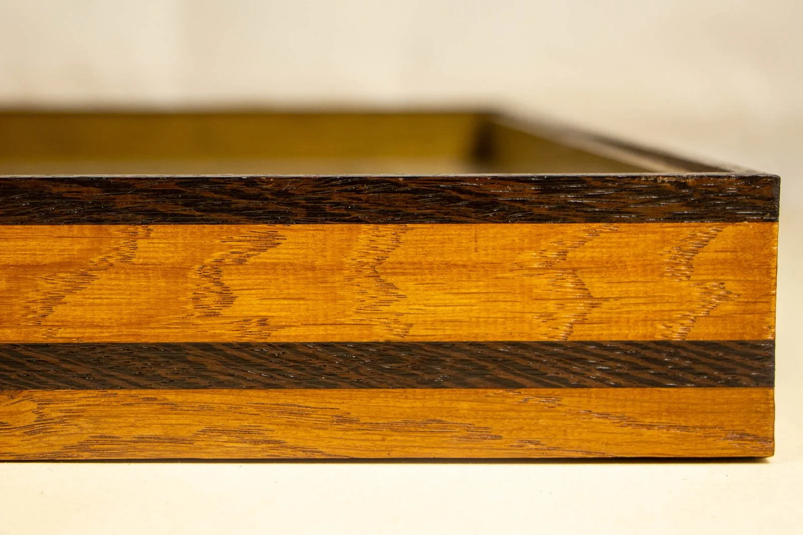 Metamorphic Entwining 003 frame: inner corner perspective, olive-gold oak liner with dark wengé cap