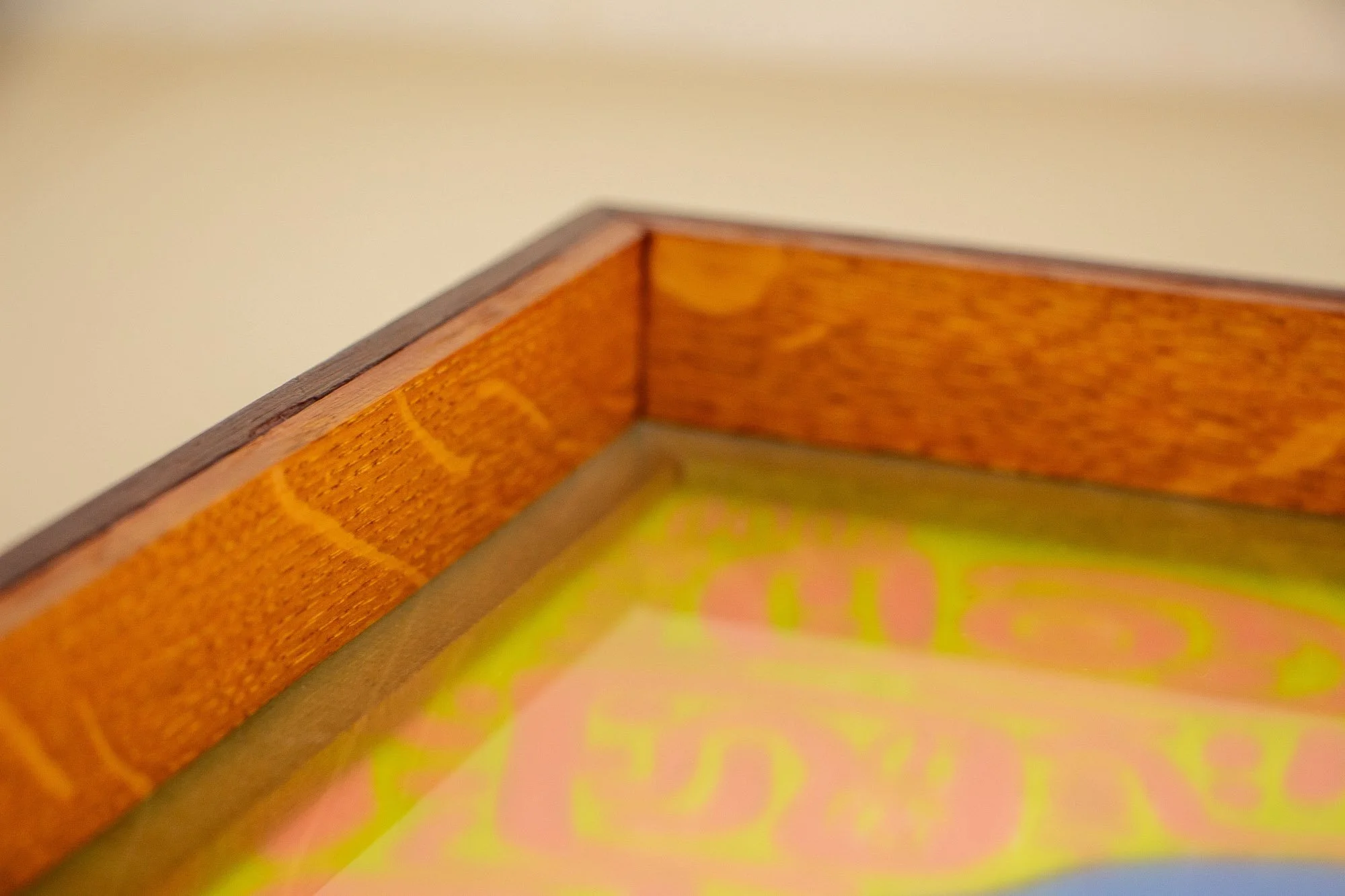 Unseen Signifiers 009 frame detail: angled close-up of the inner frame corner, showing the warm orange-brown inner wood surface and the darker inner spacer edge behind the acrylic. mahogany, oak and beech wood.