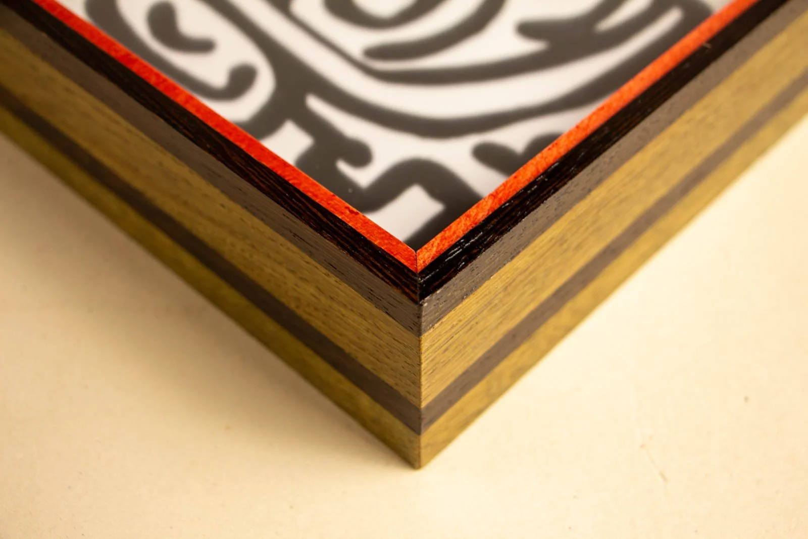 Formless Equation 002 frame: top view of mitred corner, red inner spacer around artwork, wengé rim