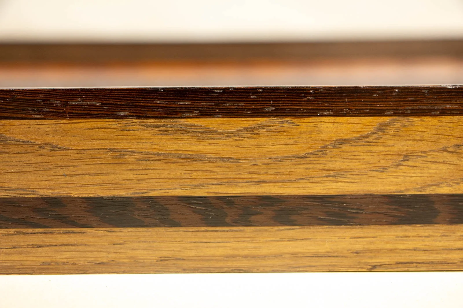 Synaptic Mythos 003 frame: profile along the long side, lean section; uninterrupted wengé stripe running true down the rail