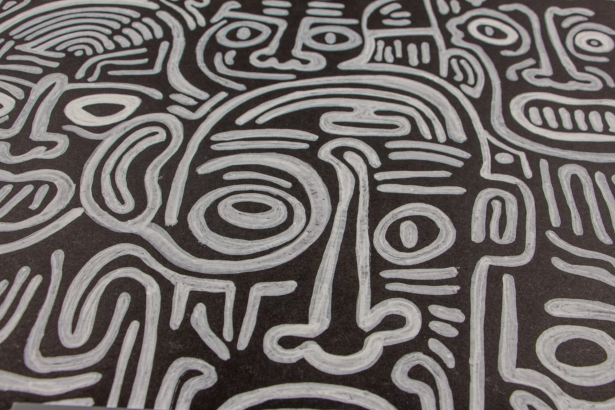 Mêlée of Discovery 001 detail: central face close-up with spiral eye, long nose, and balanced facial divisions, emphasizing the work’s direct, mask-like presence within the larger field of forms.