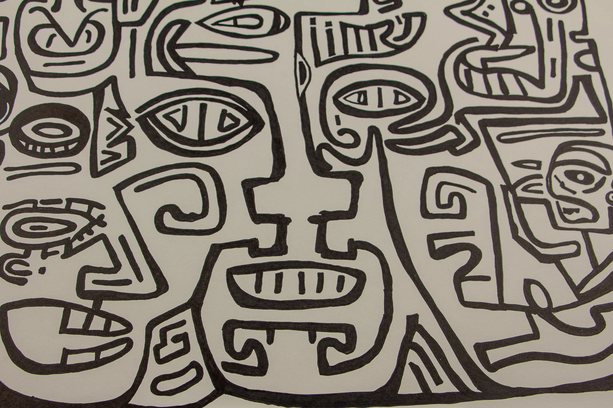 Elusive Cocoon 004 detail: close-up of a central mask-like face with almond eyes, stepped contours, and a rectangular mouth with vertical marks, surrounded by compact abstract symbols and adjacent faces.
