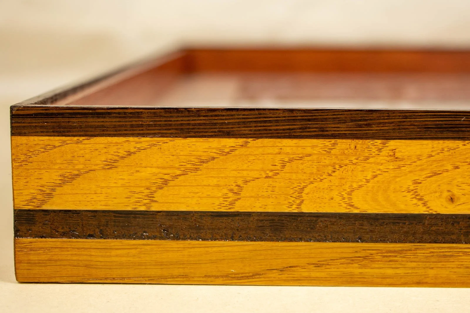 Metamorphic Entwining 002 frame: oak frame with slim wengé cap and a continuous wengé band; honey-gold grain; glass set flush