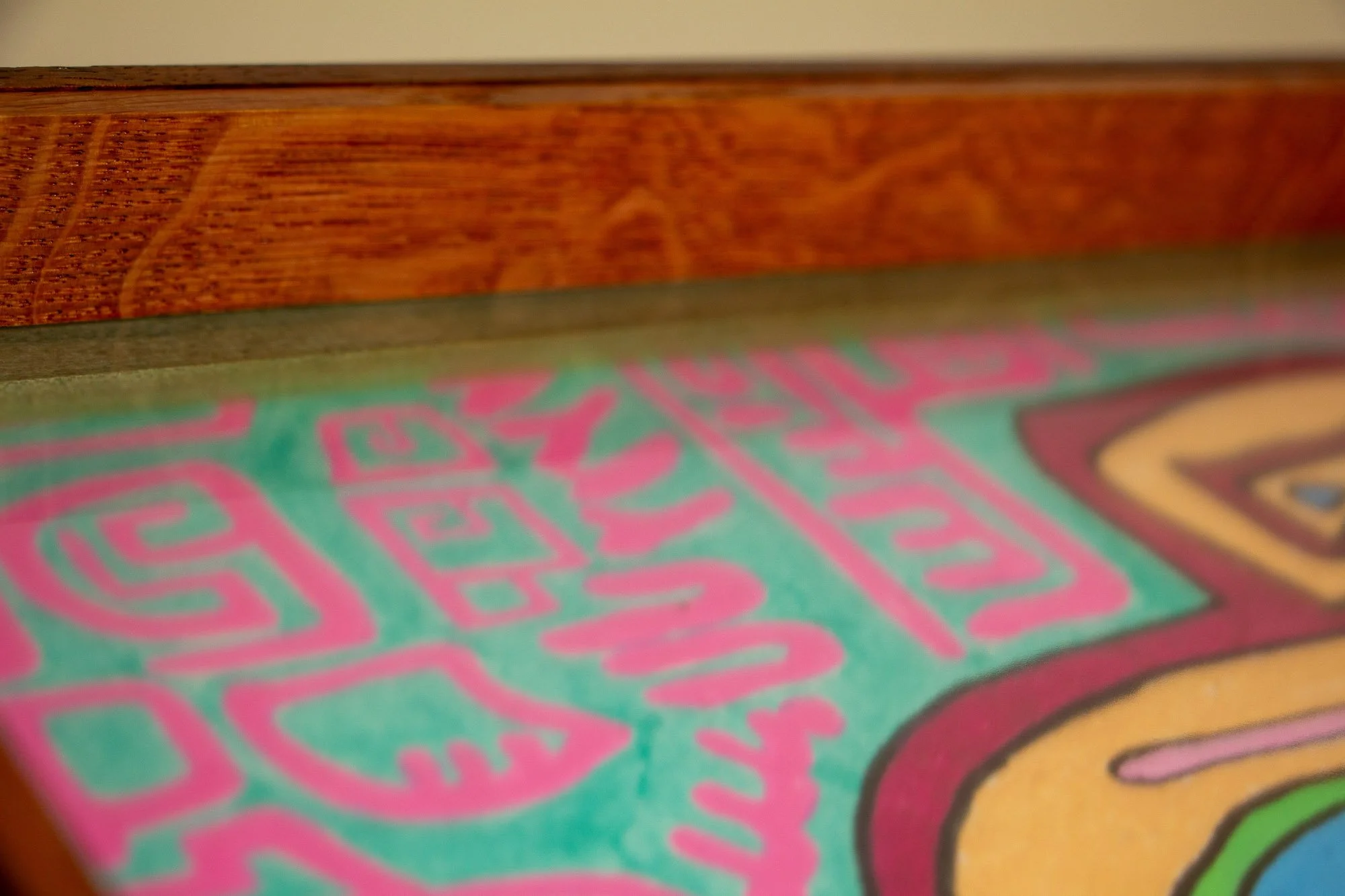 Unseen Signifiers 004 frame detail: close-up of the top interior edge, showing richly figured reddish wood grain above the olive-green inner reveal and the artwork beneath the glass. mahogany, oak and beech wood.