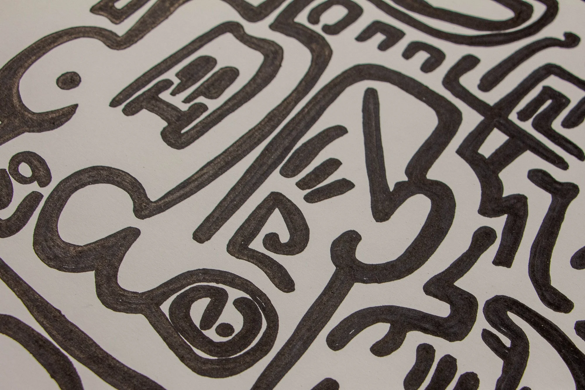 Mêlée of Discovery 004: close-up of a face-like fragment with an eye motif, curved cheek line, and angular symbols, showing the dense black linework on white paper.