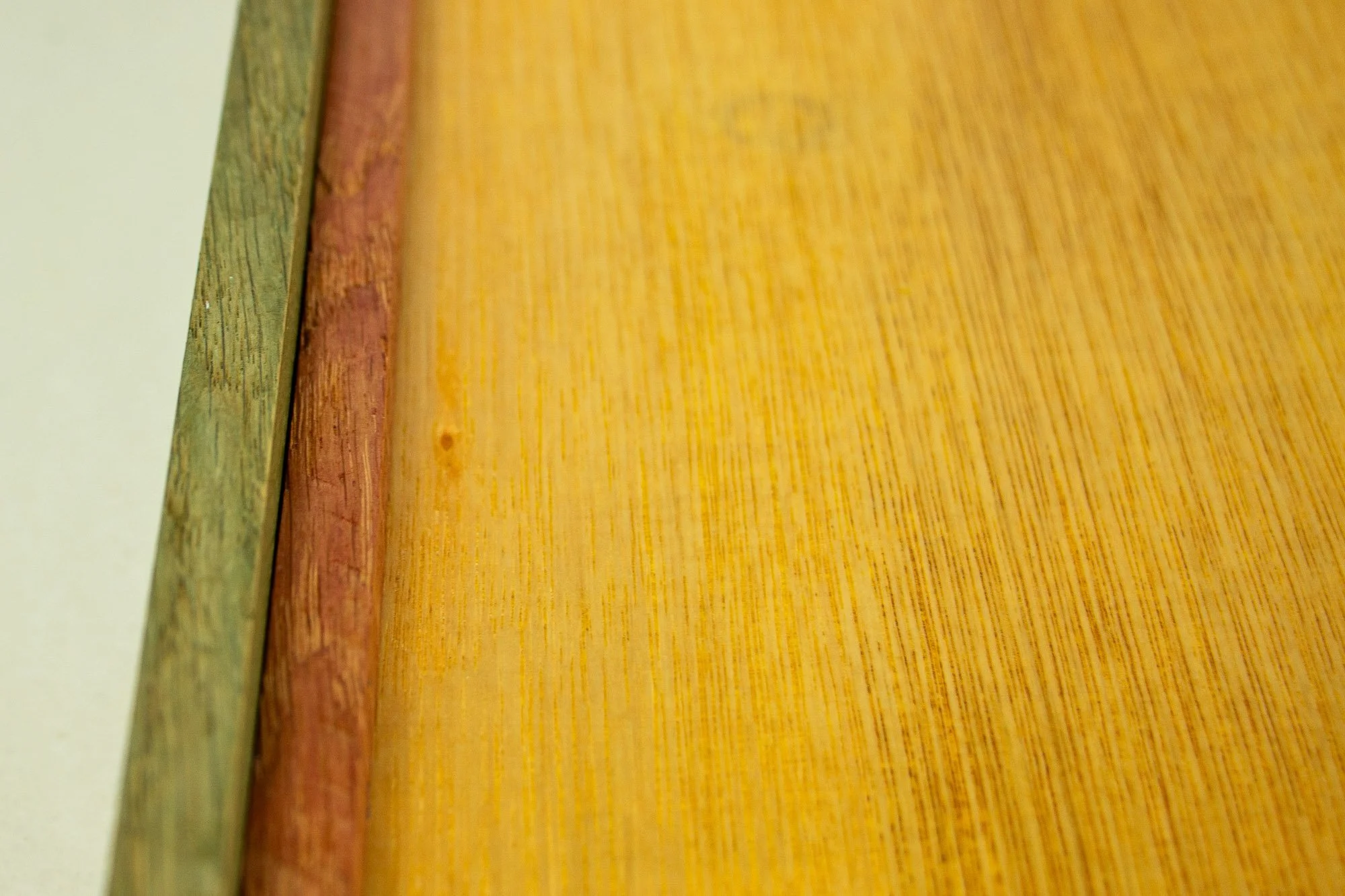 Resonant Syntax 002 frame: reverse detail of the back construction, showing the meranti plywood back panel, inner oak structure, and the layered mahogany-and-oak frame edge