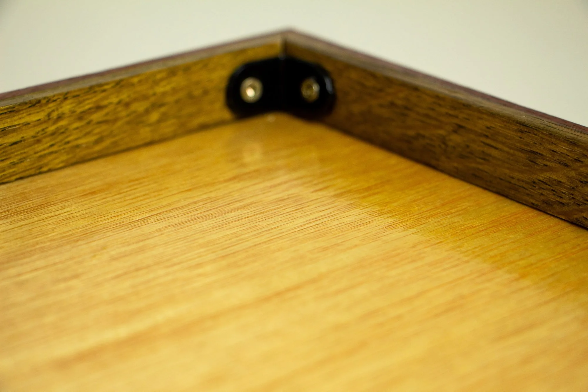 Turbulent Aegis 001 frame detail: close-up of the inner rear corner, showing the black corner brace and the precise assembly of the layered wooden frame.