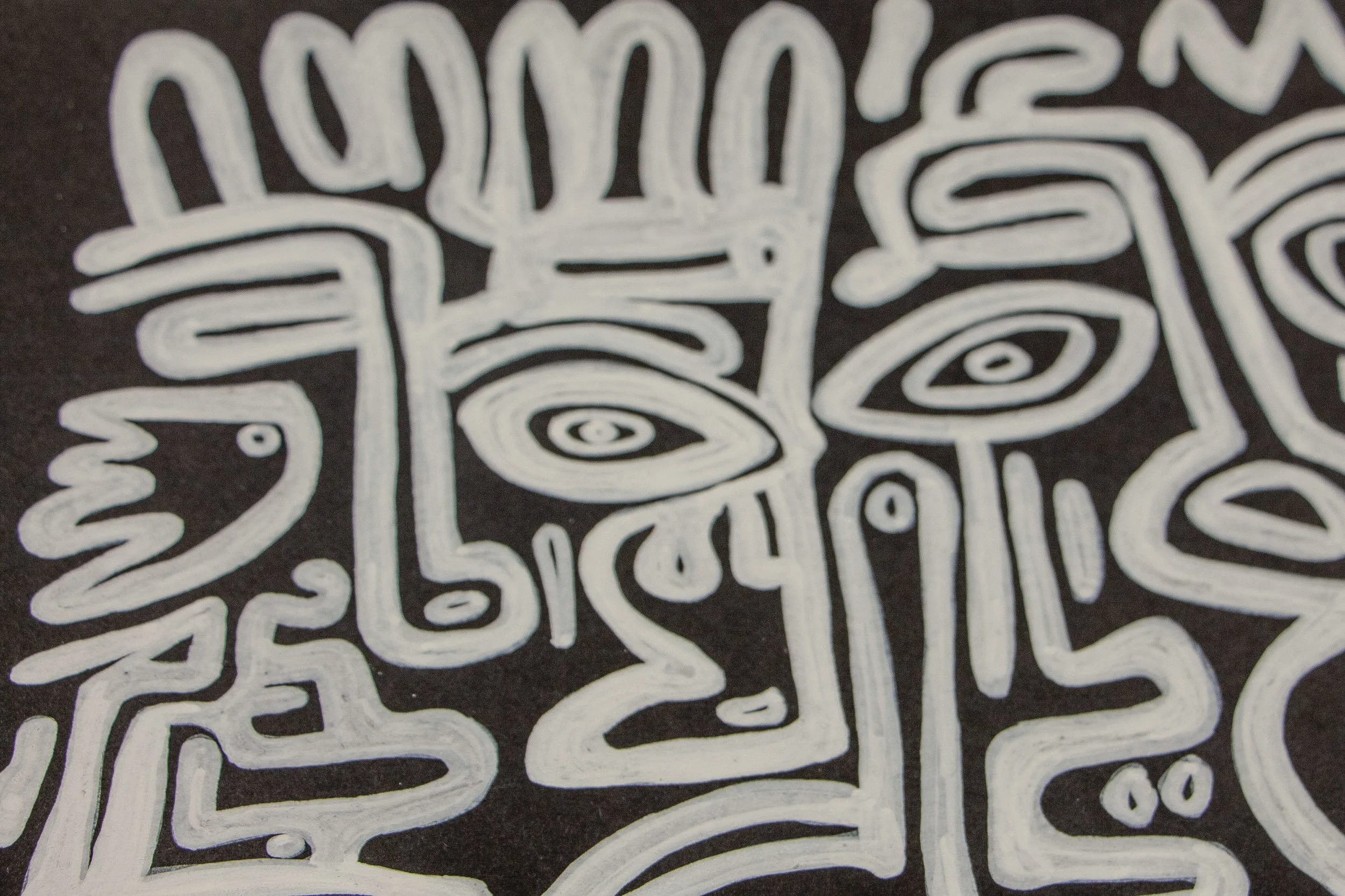 Turbulent Aegis 003 detail: close-up of a central crowned figure and surrounding abstract faces, showing the bold white outlines, spiral eye forms, and the tactile brush texture on the dark background.