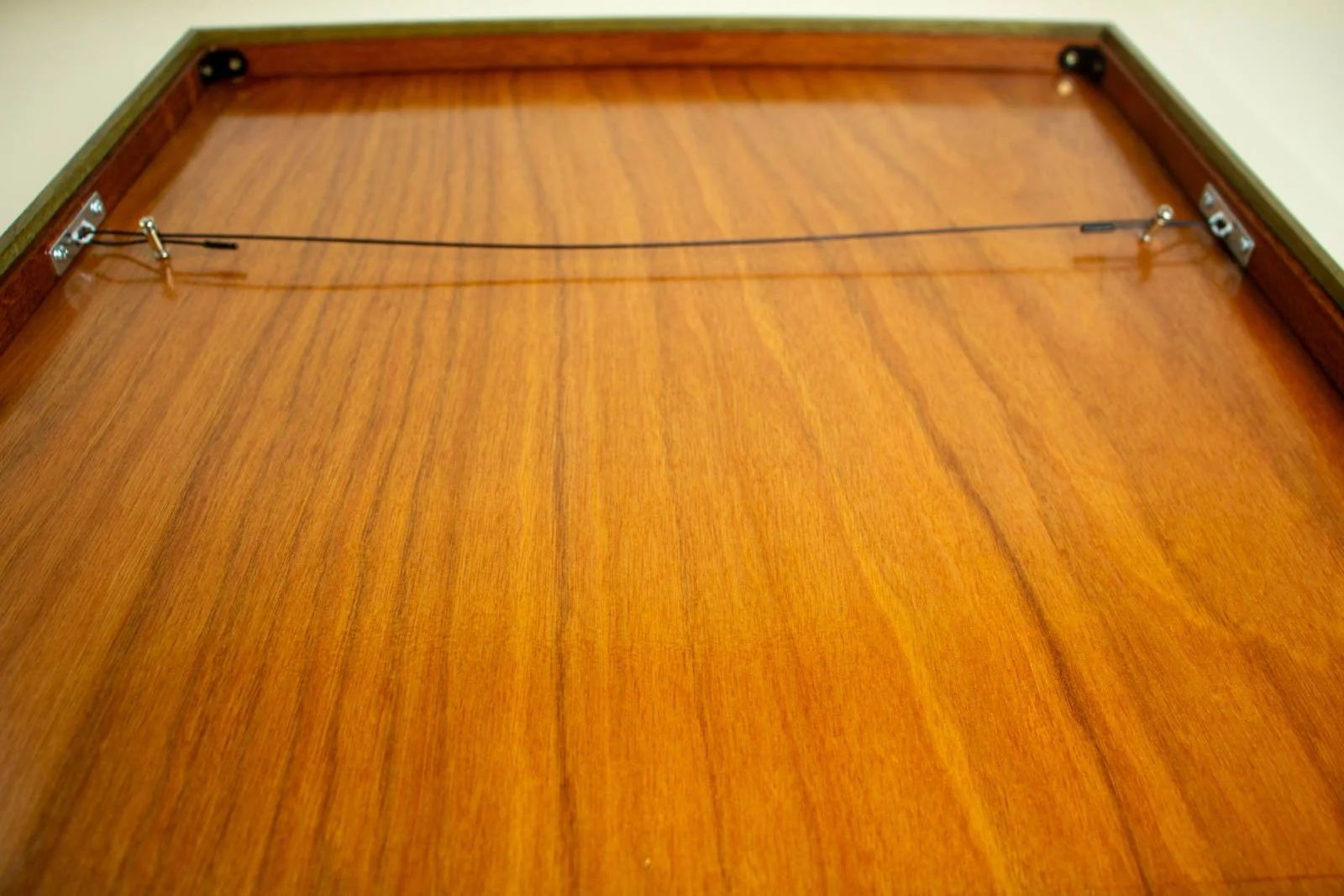 Formless Equation 002 frame detail (back): full panel with steel hanging wire and hardware mounted in oak rebate