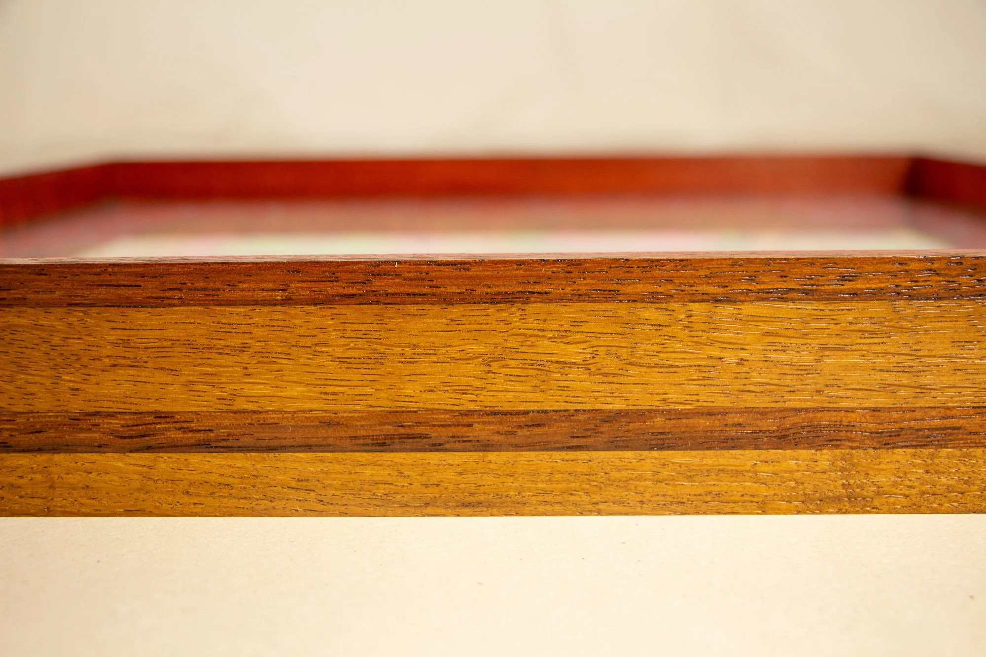 Unseen Signifiers 008 frame detail: straight-on close-up of the front frame edge, highlighting the horizontal wood banding and the clean, deep box-frame profile. mahogany, oak and beech wood.