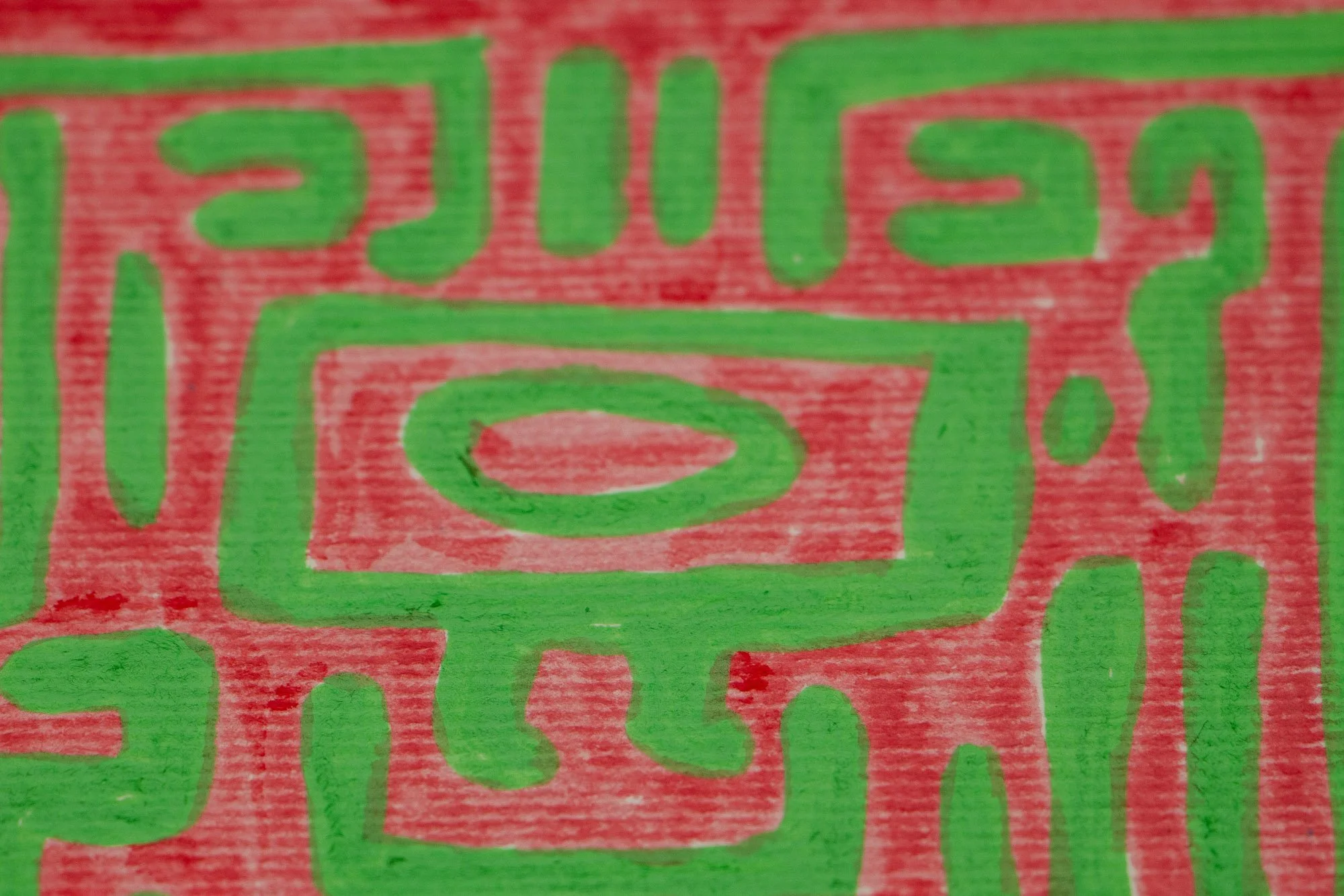 Unseen Signifiers 001 detail: close-up of the pink background with green abstract signs and geometric forms, including a square-within-square motif and a keyhole-like figure.