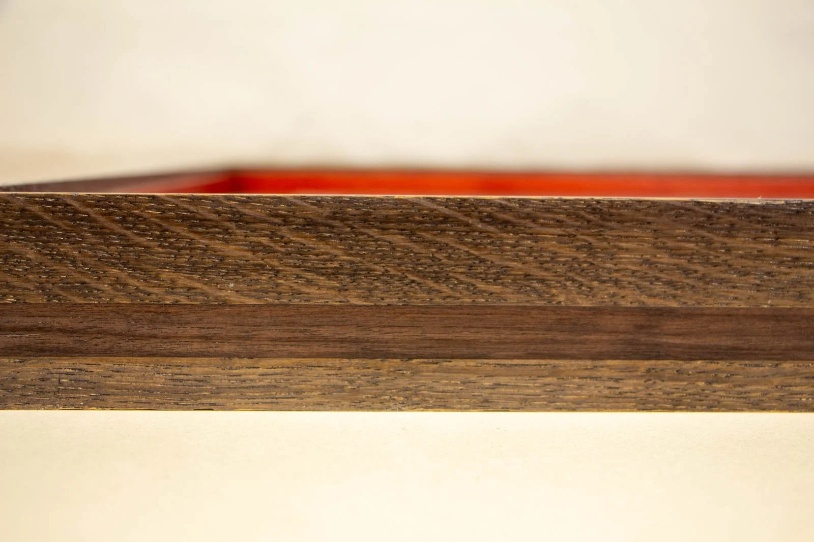 Flux Impromptu 001 frame: front face, slender top edge with a walnut line; red inner space faintly reflecting behind the glass