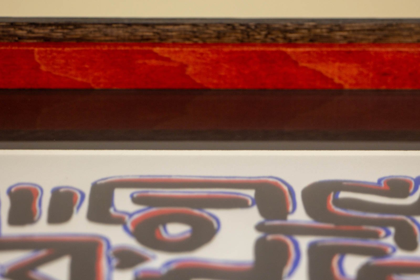 Flux Impromptu 001 frame: top edge, red spacer strip visible behind the glass; dark outer rim contains the image