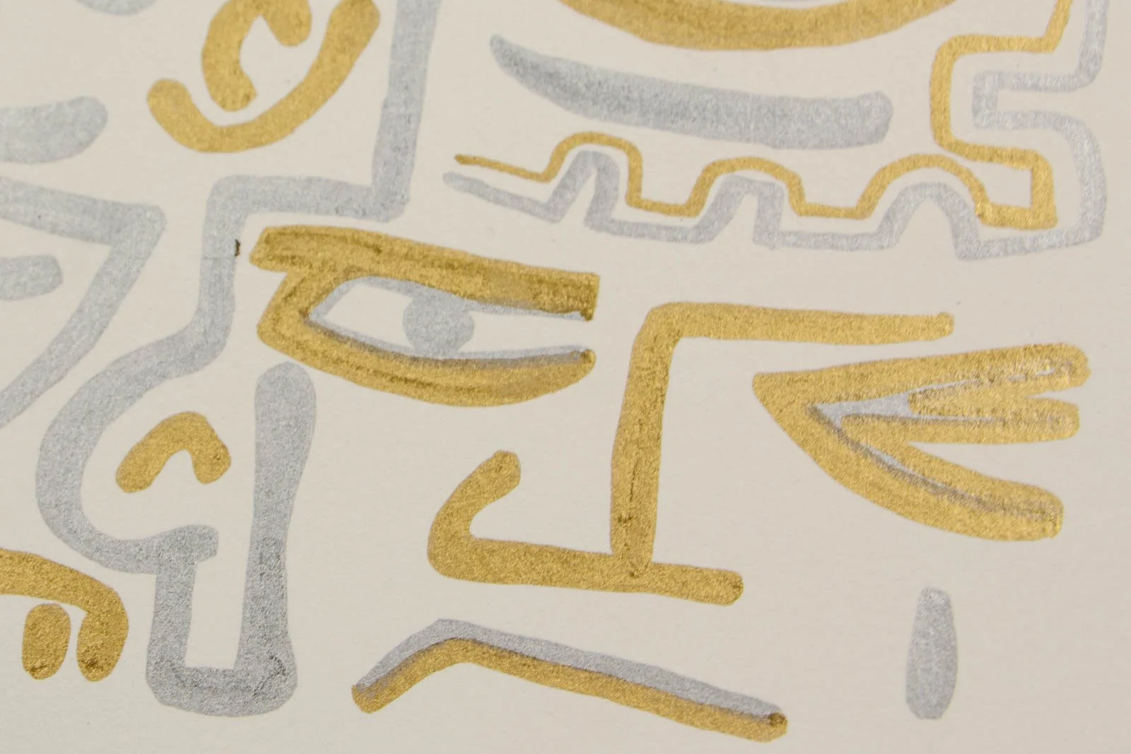 Golden Nostalgia 002 detail: tight detail, eye glyphs; crisp gold accents with silver fill on heavy cream paper