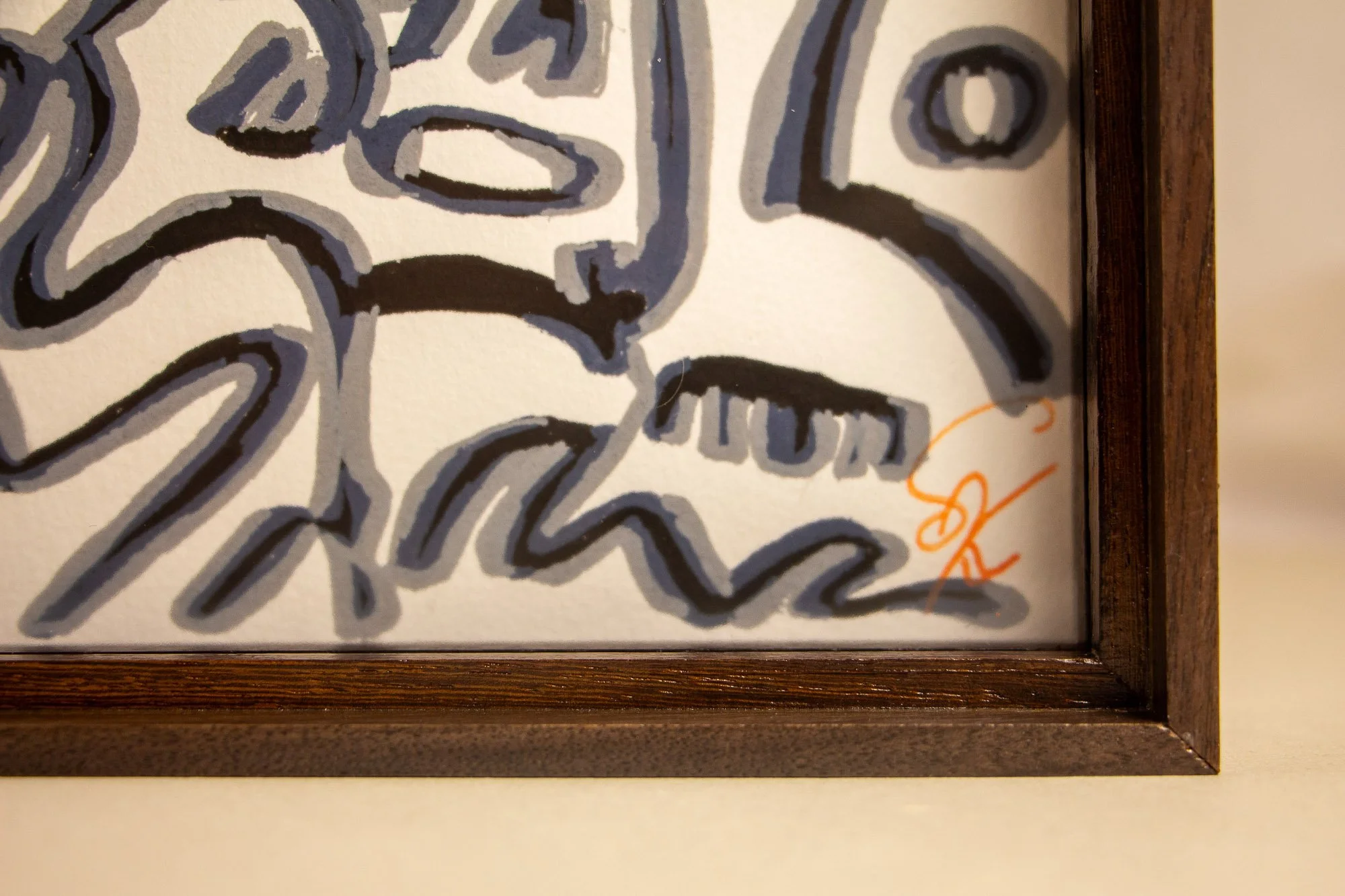 Luminous Parallax 004 frame: detail of the lower corner with part of the orange signature visible, showing how the dark-toned frame encloses the drawing with a precise and understated finish.