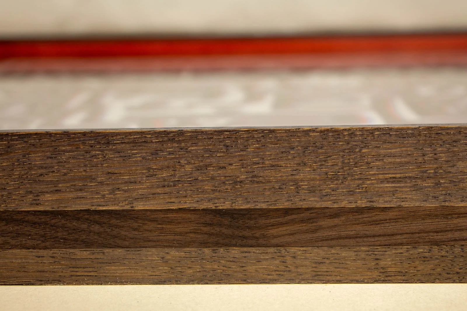 Flux Impromptu 003 frame: side panorama, tiered oak faces framing the mid-band; soft hint of the red interior in the background