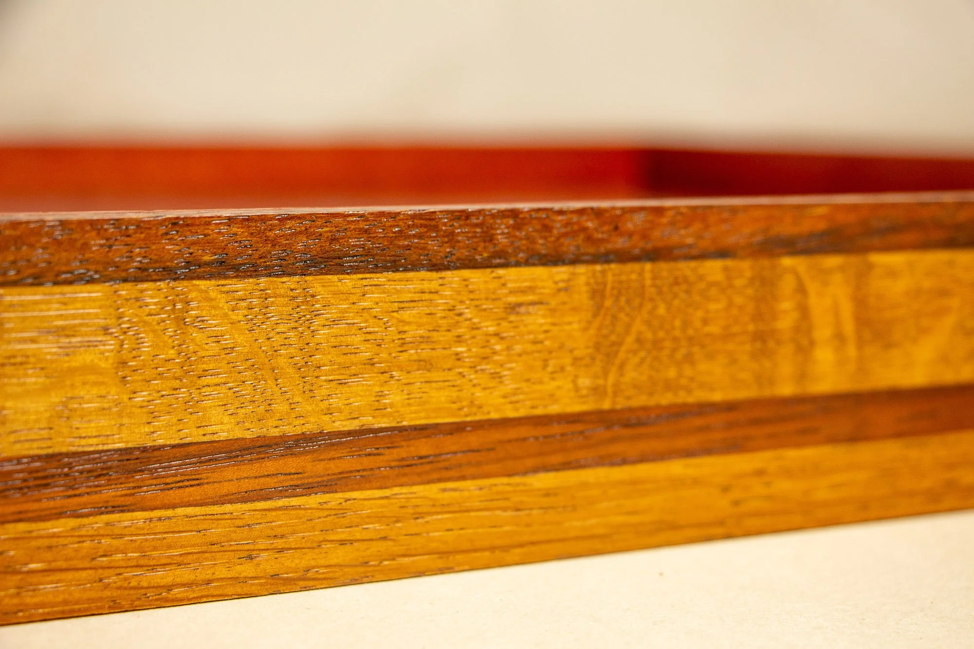 Unseen Signifiers 008 frame detail: angled close-up of the front frame edge, emphasizing the polished layered wood construction and the depth of the box frame. mahogany, oak and beech wood.