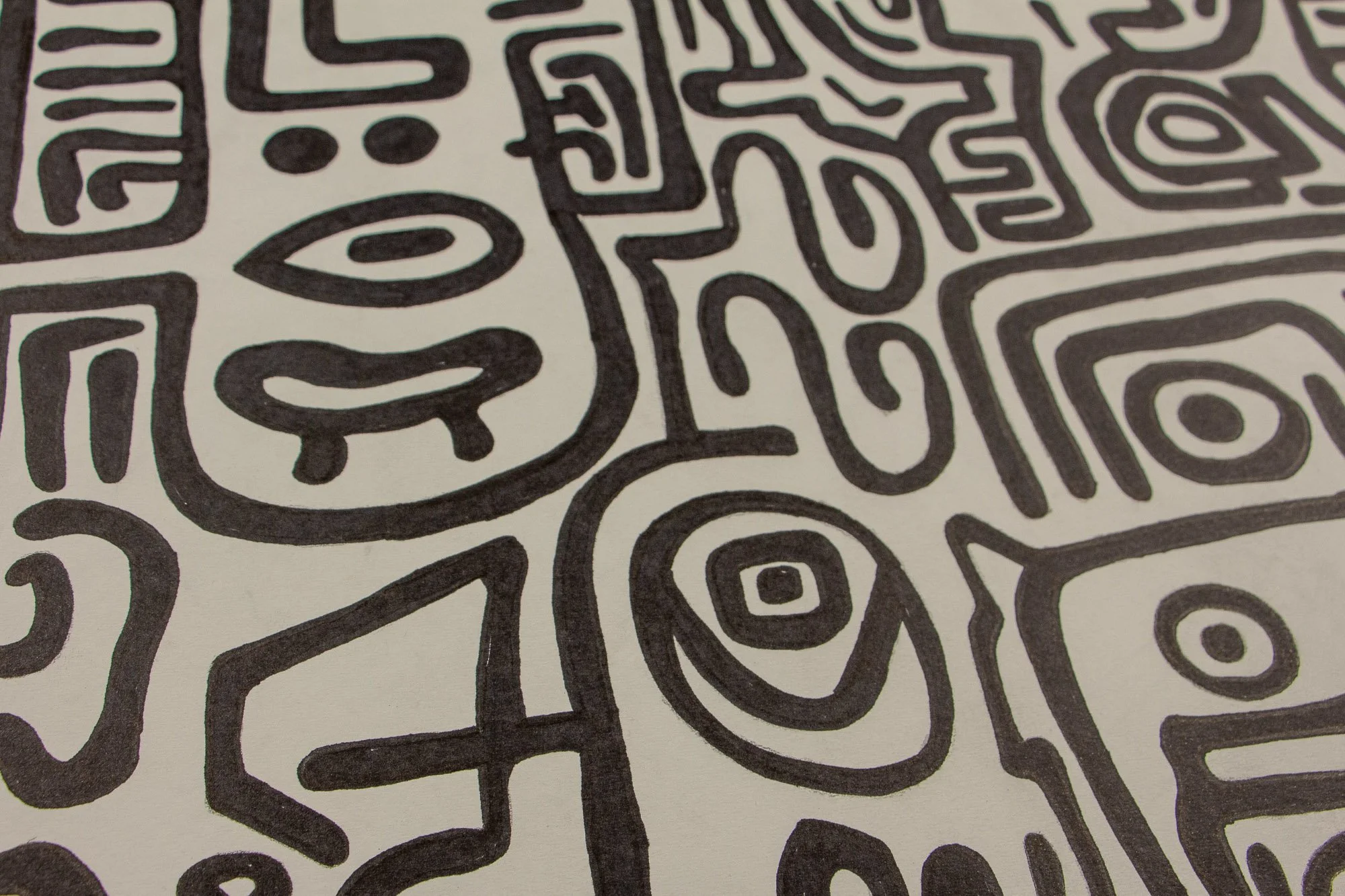 Resonant Syntax 003 detail: angled close-up of the lower-left field, with a simplified face, almond eye, small curved mouth, and adjacent concentric eye motif; thick black lines defining the clustered forms