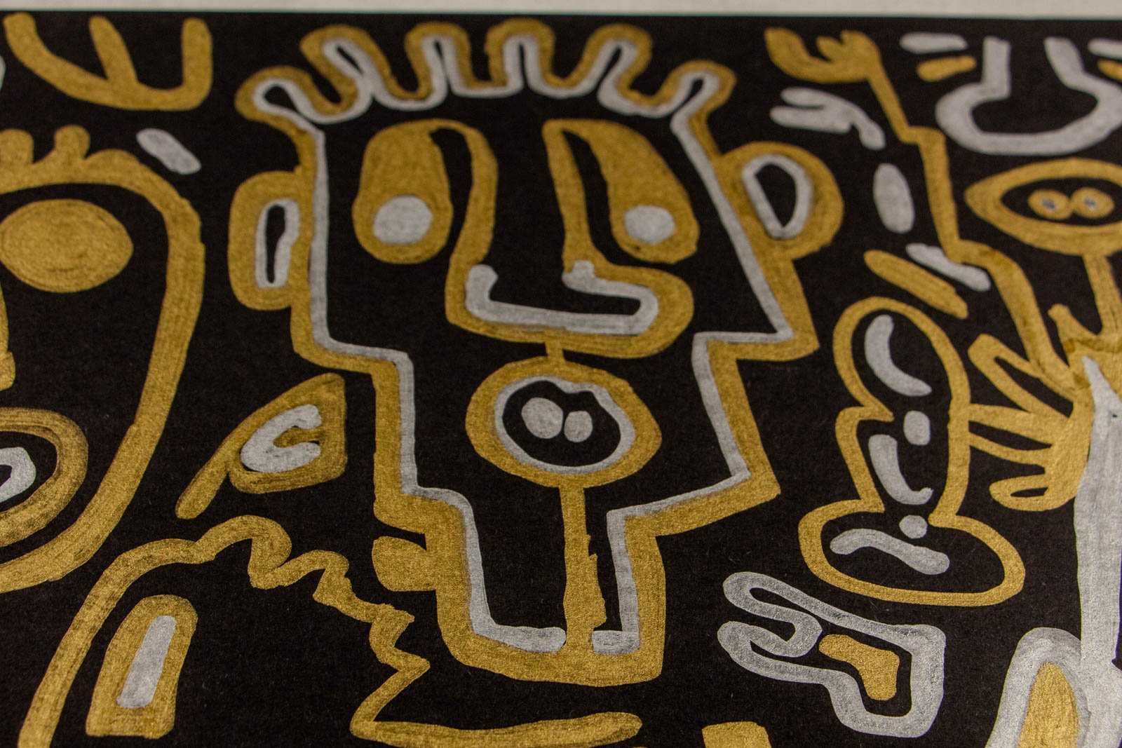 Golden Nostalgia 001 detail: upper-left corner, oval eye and scalloped border; soft paper grain showing through the metallic ink