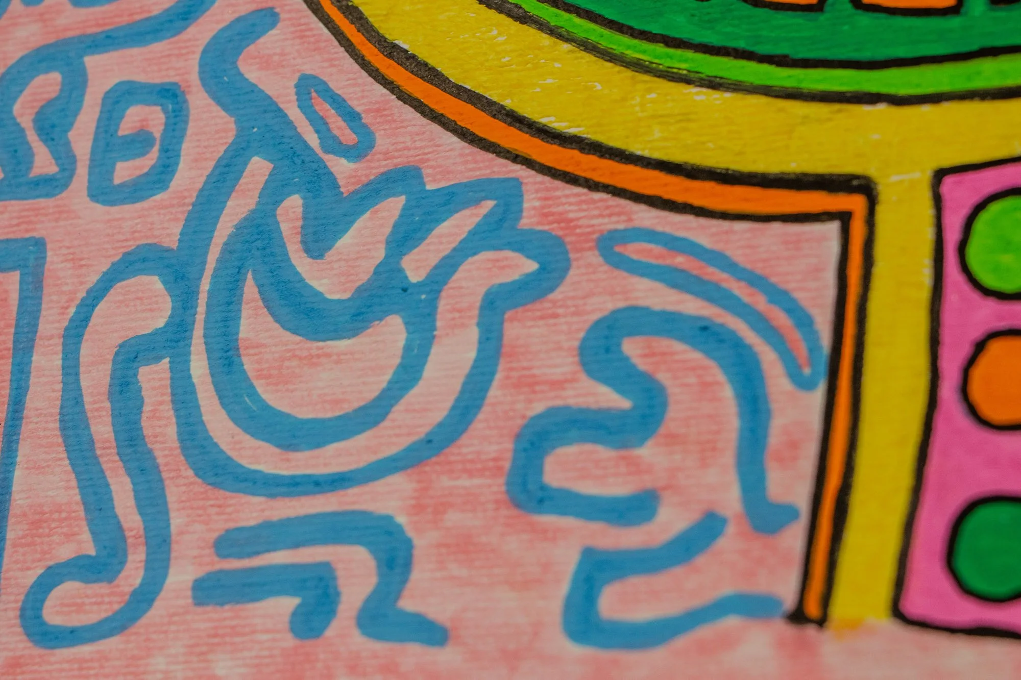Unseen Signifiers 006 detail: lower-left close-up of the surrounding field, highlighting a light-blue flame-like symbol on the pink background beside the yellow and orange edge of the face.