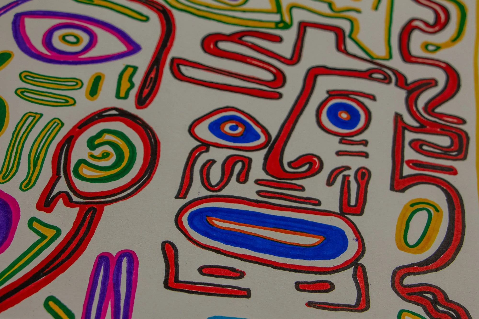 Eclipsing Gravitas 002 detail: close-up of a red face-like figure with bright blue eyes and a blue oval mouth, surrounded by spirals, curved lines, and neighboring abstract forms in green, yellow, and magenta.