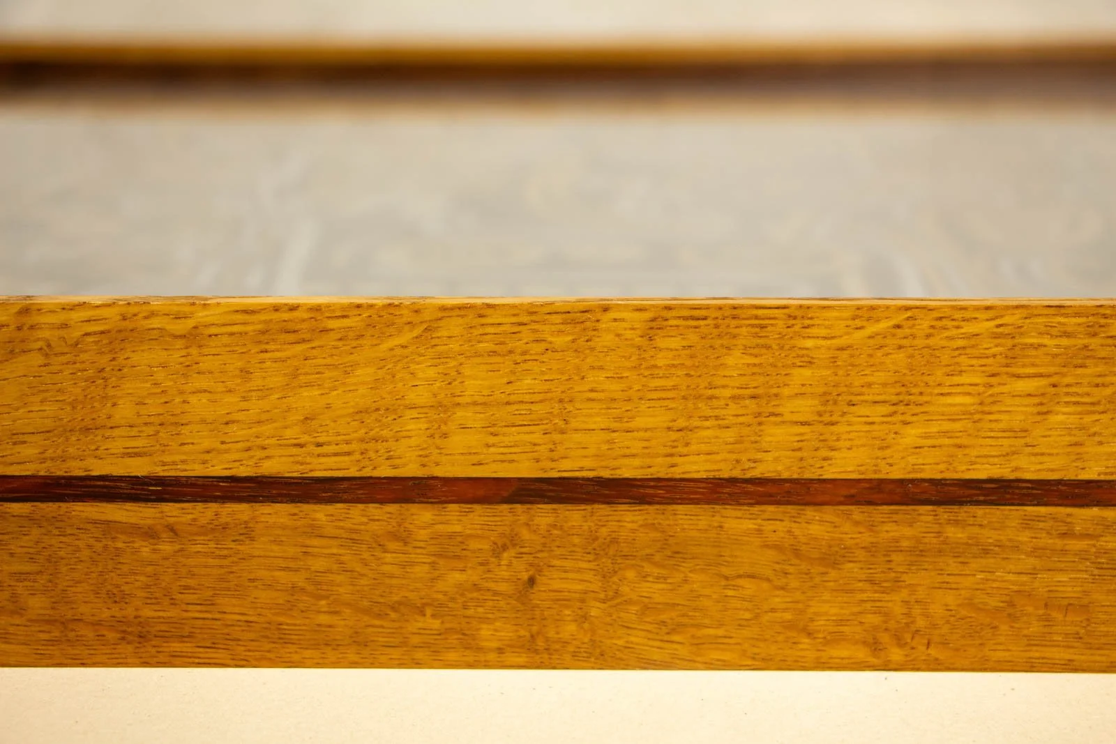 Golden Nostalgia 004 frame: mid-rail close-up, clean oak face above and below the inlay