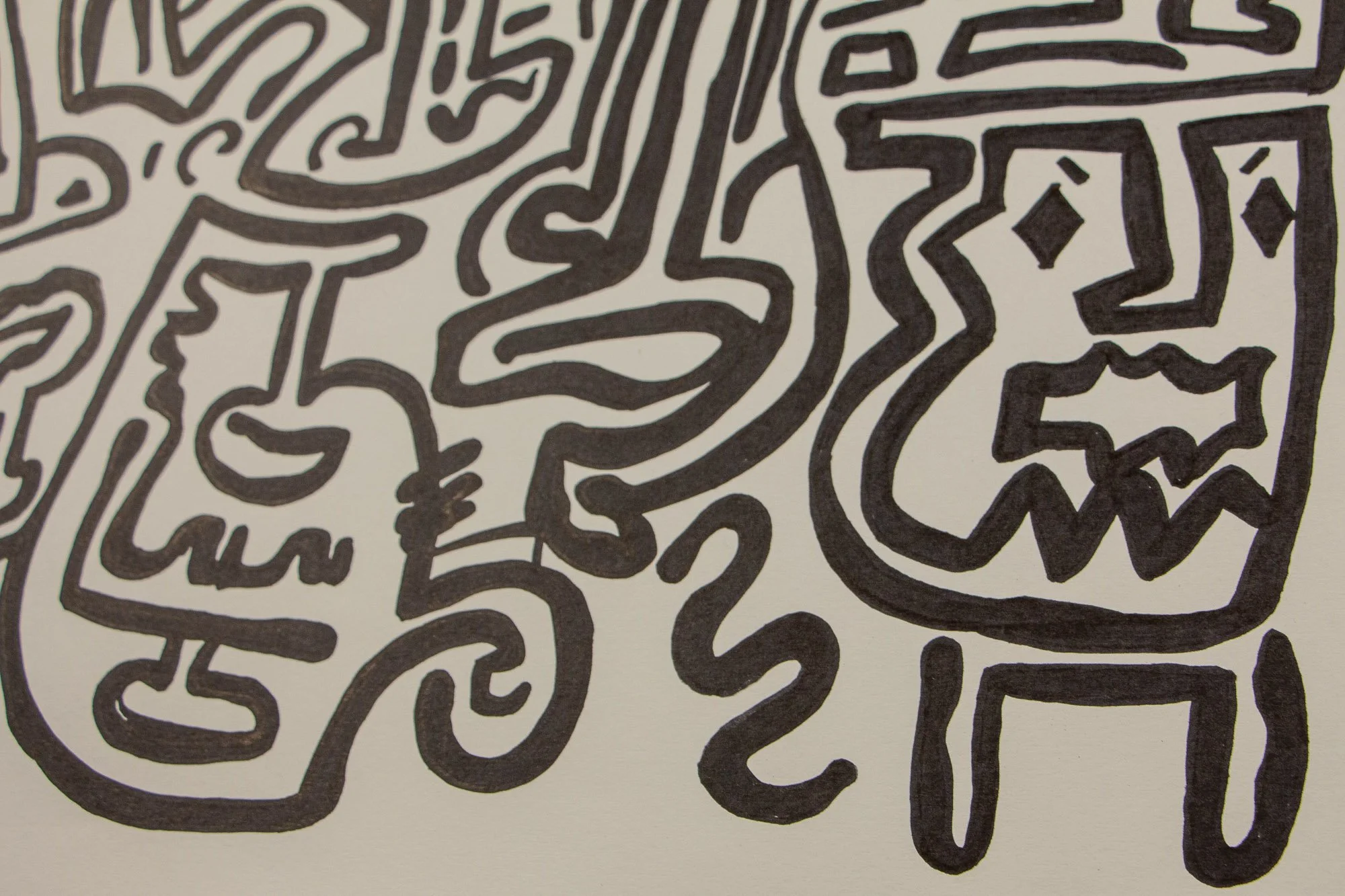 Elusive Cocoon 003 detail: close-up of the lower-right area, showing a face-like vessel form with diamond-shaped eyes and a zigzag mouth beside curving linework, spiral tail-like forms, and adjoining symbolic contours.