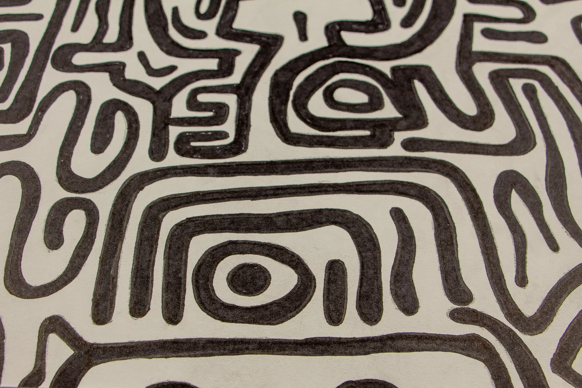 Resonant Syntax 003 detail: close-up of a nested eye form enclosed within stepped, arch-like contours; thick black linework creating a concentrated focal rhythm on the paper surface