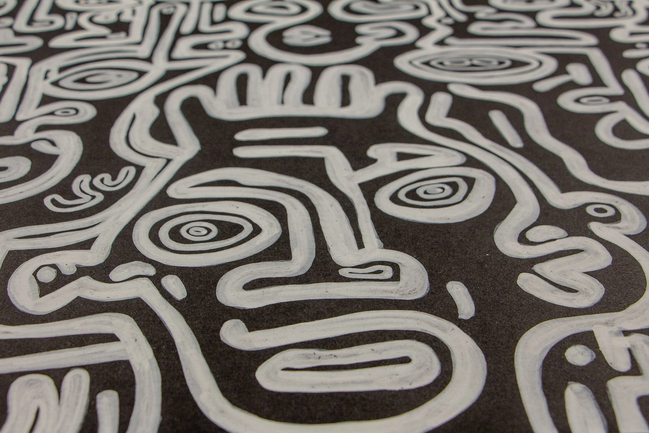 Turbulent Aegis 003 detail: close-up of the painted surface showing a face-like figure with spiral eyes and flowing white lines across the dark ground, revealing the texture and hand-drawn rhythm of the composition.