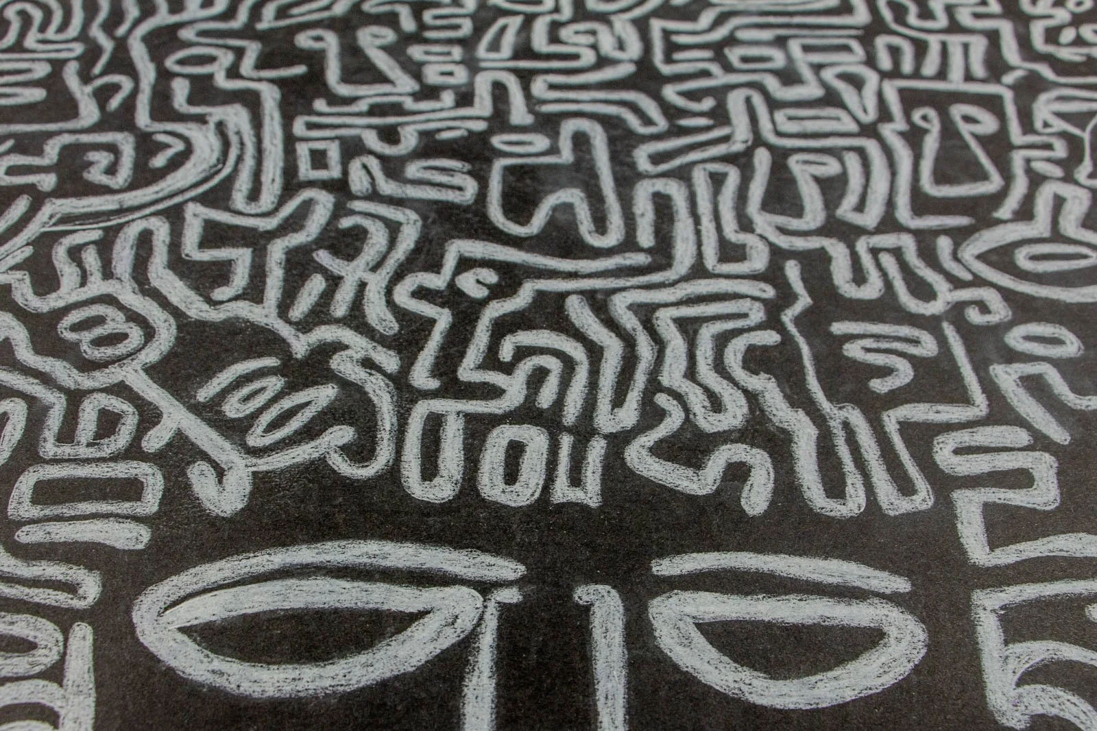 Synaptic Mythos 004 detail: low raking macro, dense labyrinth of chalk-white glyphs; paper tooth softly scumbled