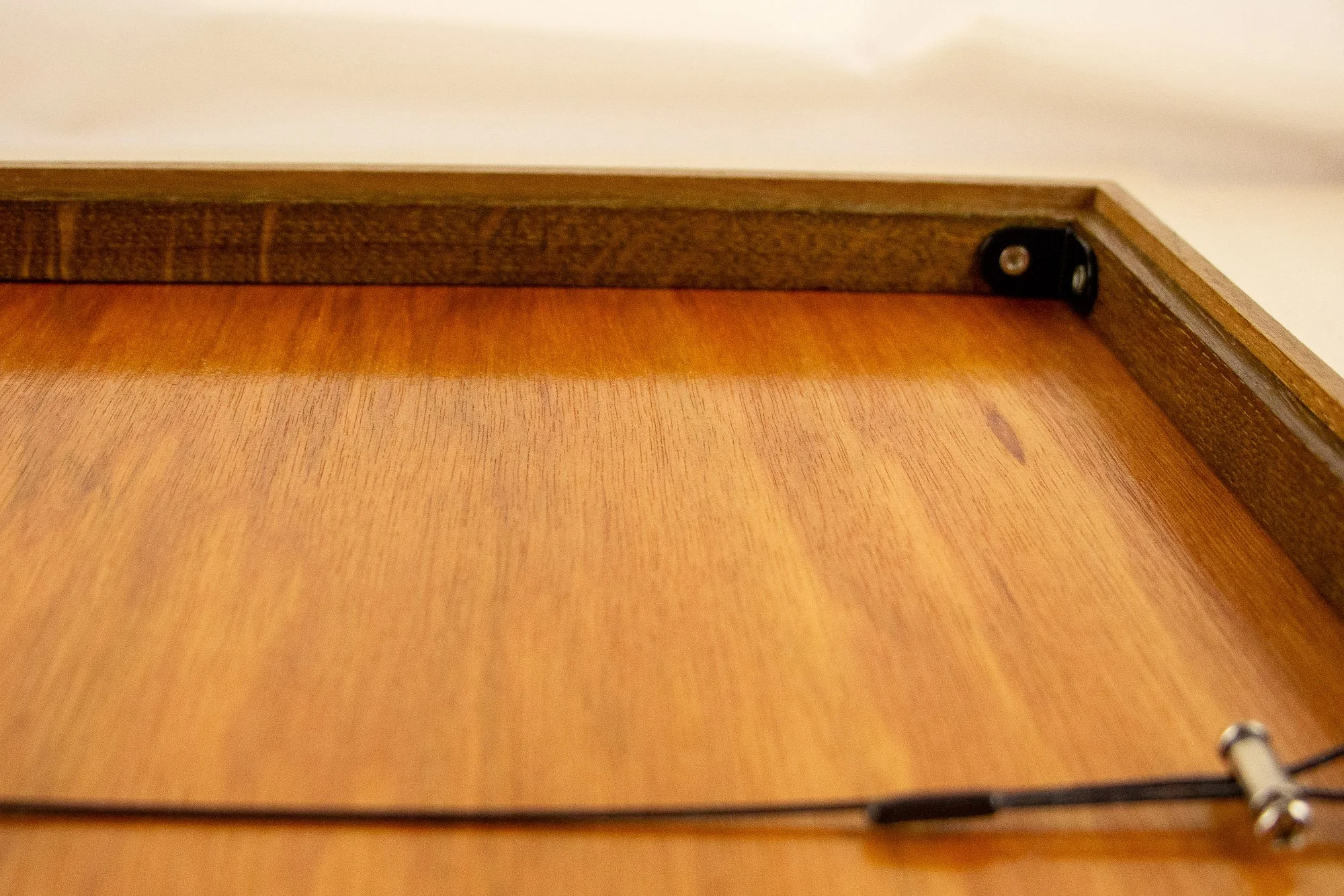 Veiled Alchemist 001 frame detail: reverse view of the frame interior, showing the warm-toned back panel, inner corner bracket, hanging wire, and the clean structural finish on the rear.