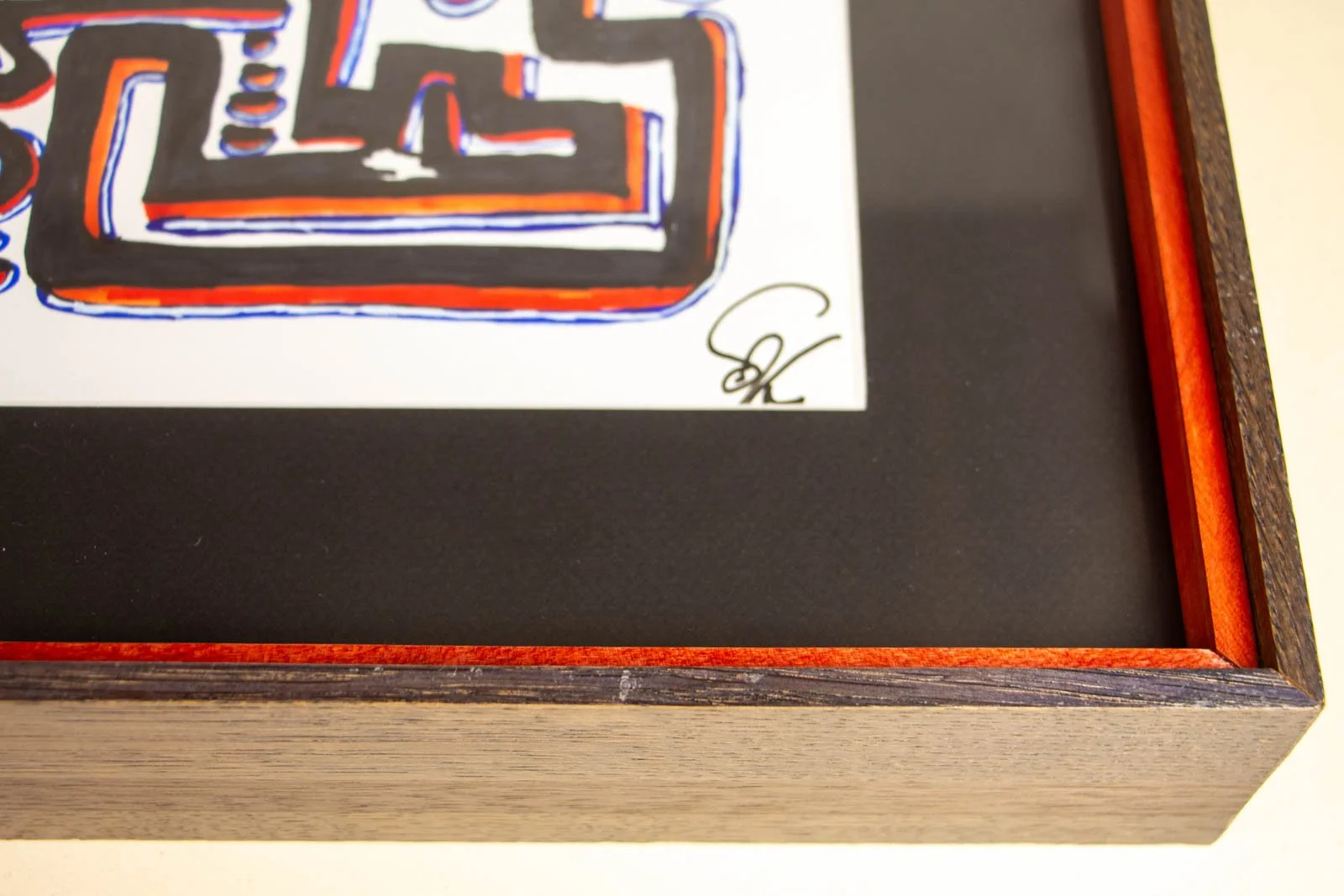 Flux Impromptu 003 frame: signature corner, artist mark with slim white paper reveal; black window mat; red liner and oak surround
