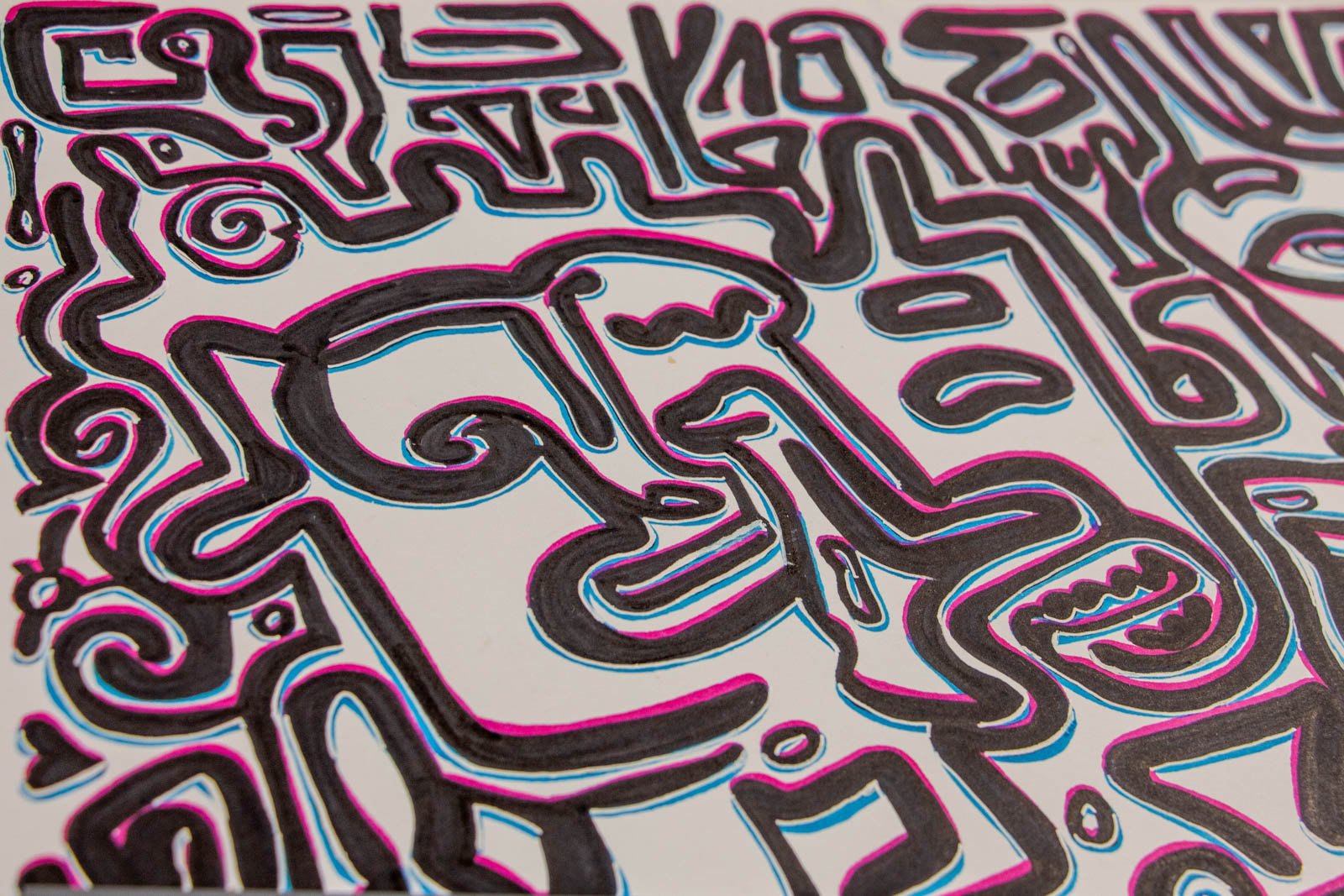 Silence’s Caesura 001 detail: angled close-up, profile with curled brow and long nose; smiling mouth glyph; swirling scrolls; pink/blue halo lines