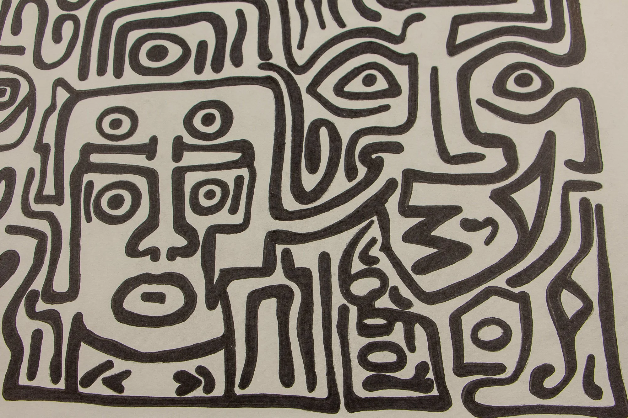 Resonant Syntax 003 detail: wider close-up of the central field, with the frontal mask beside a sharp zigzag profile and surrounding eye motifs; interlocking black contours across warm white paper