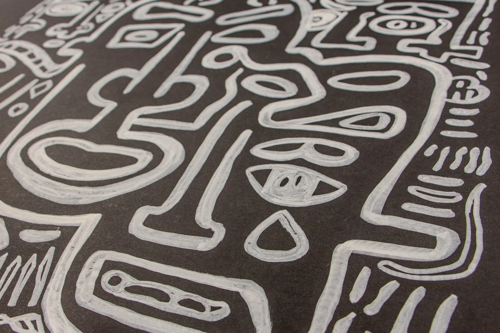 Metamorphic Entwining 001 detail: overlapping profiles with sweeping cheek lines and nested ovals, gentle brush texture, white ink on black paper