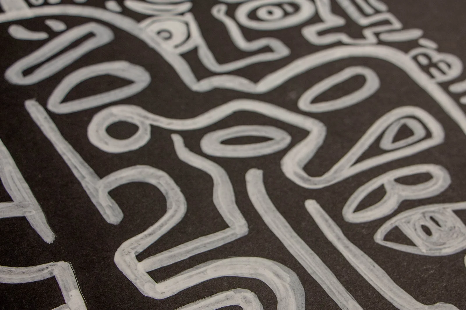 Metamorphic Entwining 001 detail: elongated face with tear symbol and floating oval eyes, crisp linear pathways, white ink on black paper