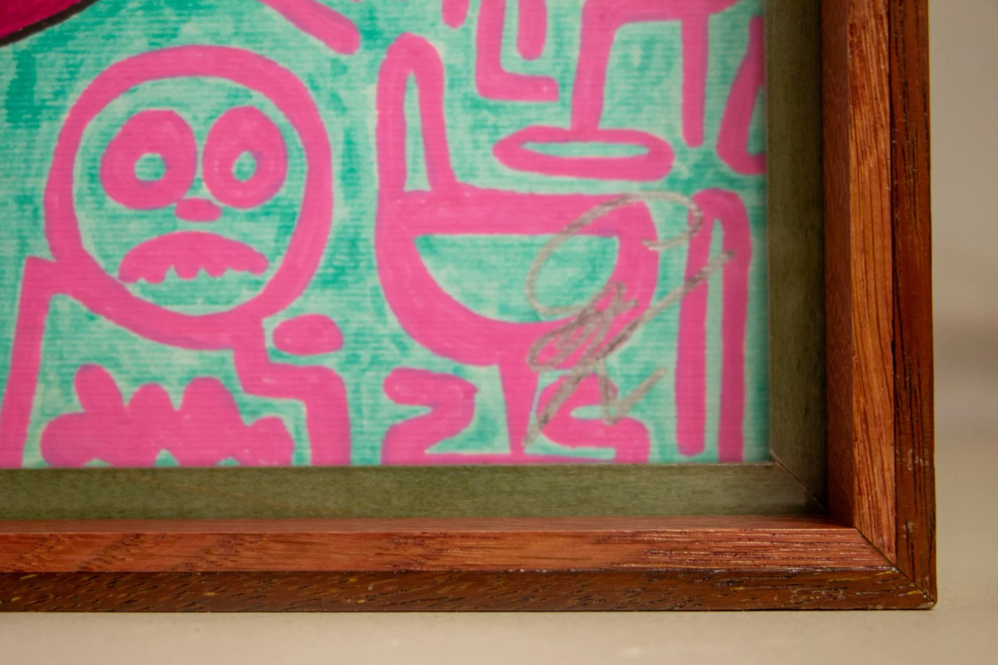 Unseen Signifiers 004 frame detail: lower-right corner detail with silver signature visible behind the glazing, framed by the olive-green inner reveal and warm red-brown outer moulding. mahogany, oak and beech wood.