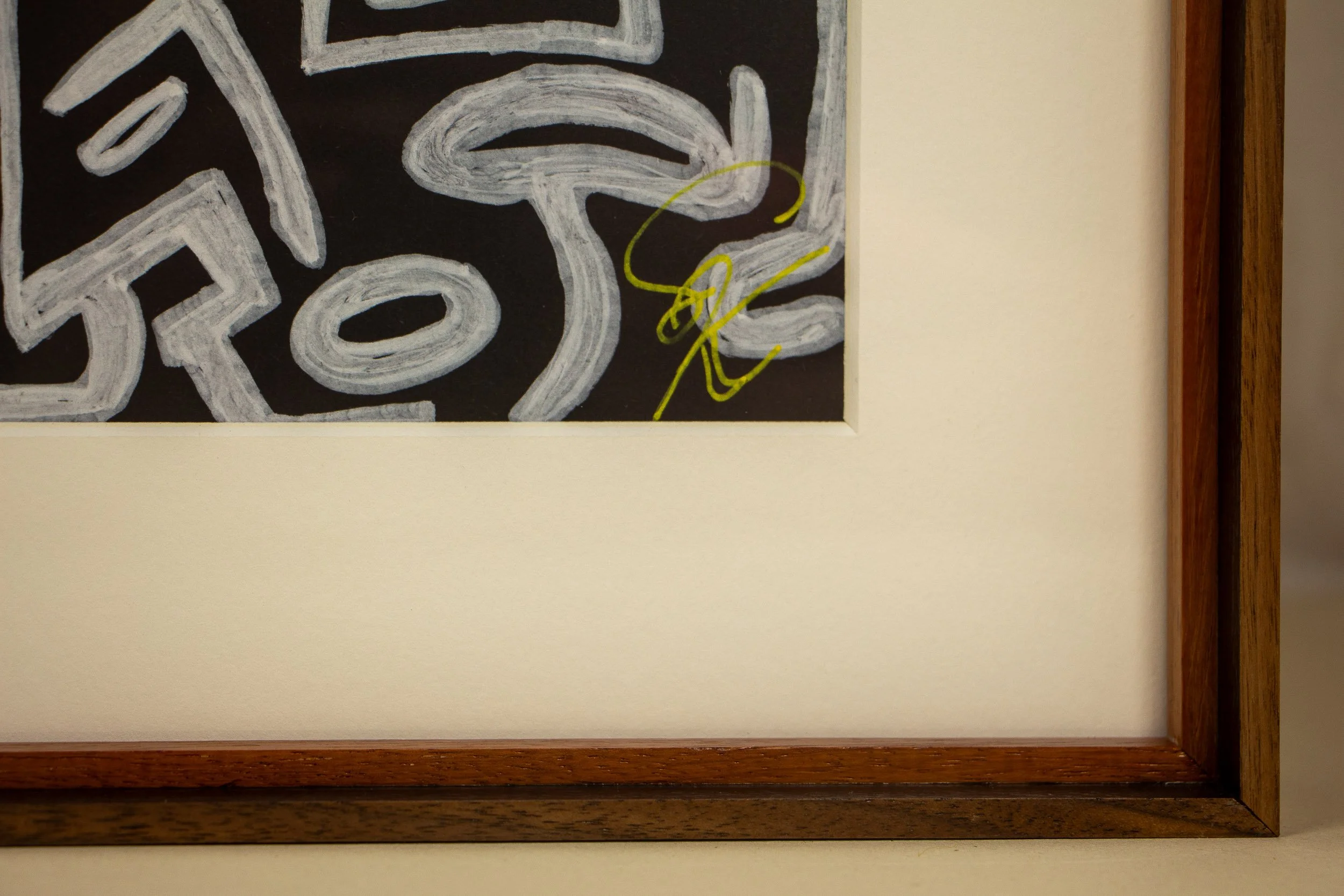 Mêlée of Discovery 005 frame detail: corner crop of the framed work, showing the cream mount, warm inner wooden liner, and layered outer frame profile around the artwork.