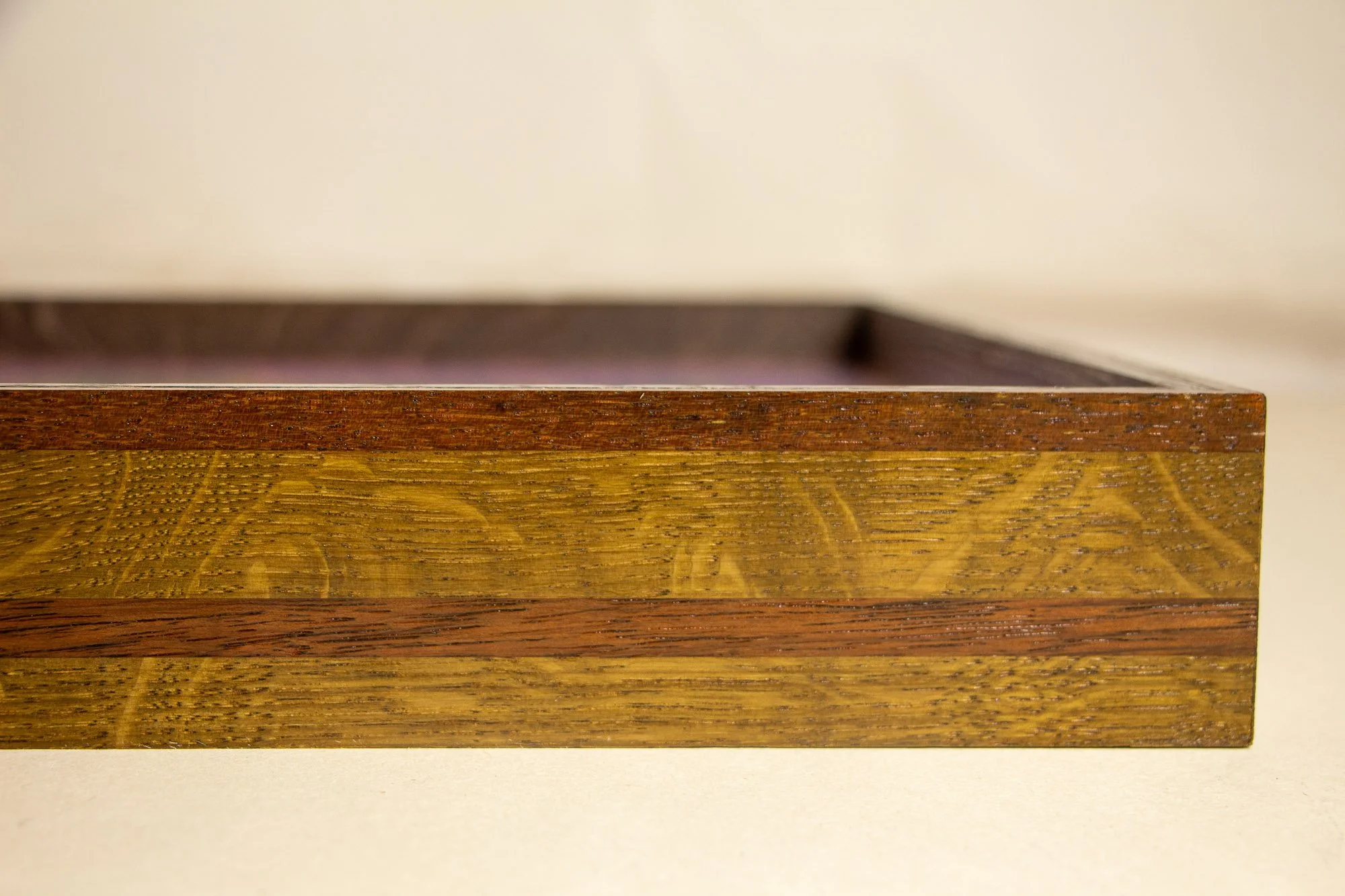 Unseen Signifiers 007 frame detail: angled side view of the frame profile, emphasizing the laminated wood construction and warm natural grain. mahogany, oak and beech wood.