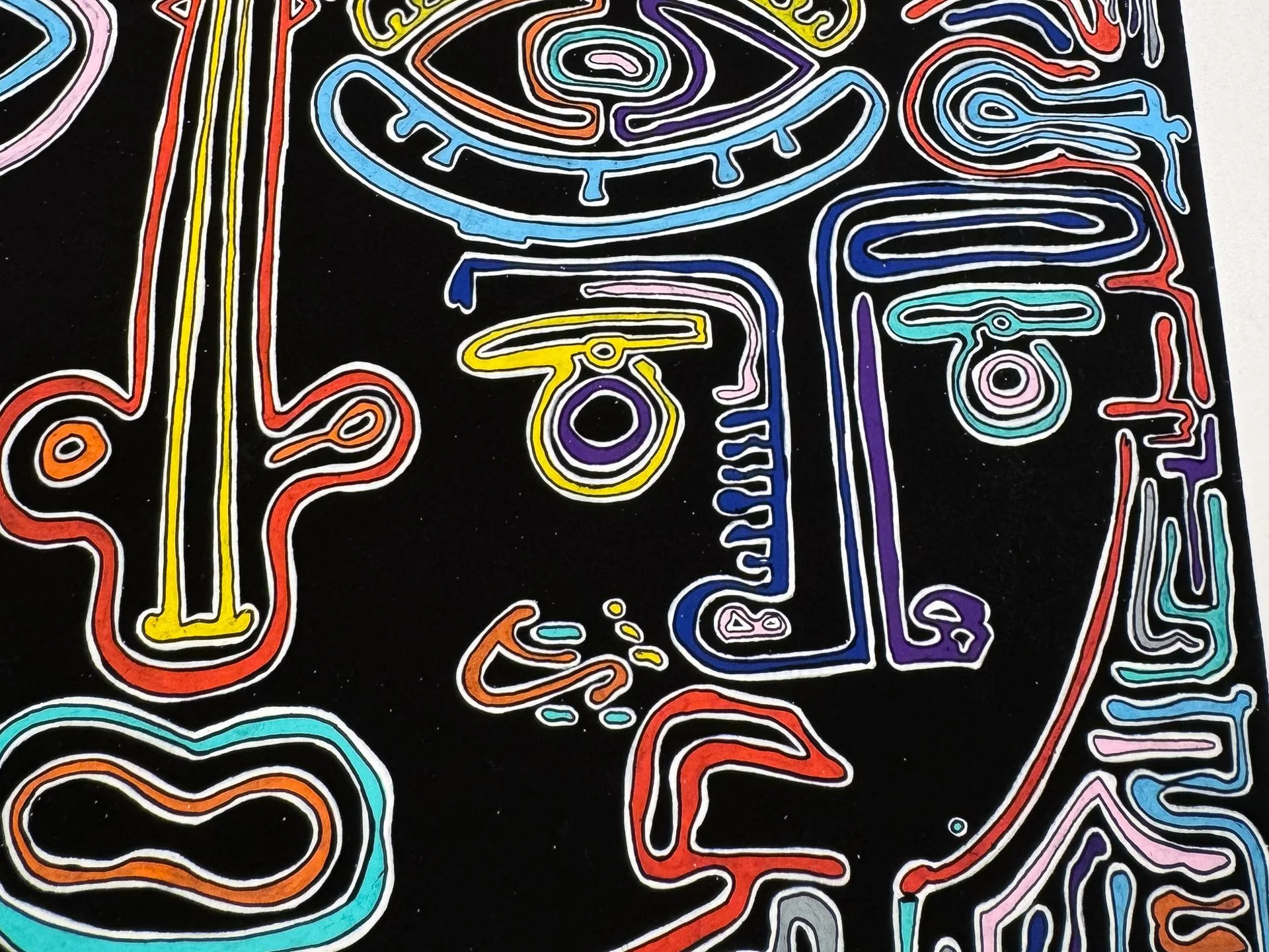 Close-up of the right side of the face, featuring the right eye, cheek, mouth area, and surrounding maze-like motifs in light blue, yellow, orange, violet, red, and grey against black.