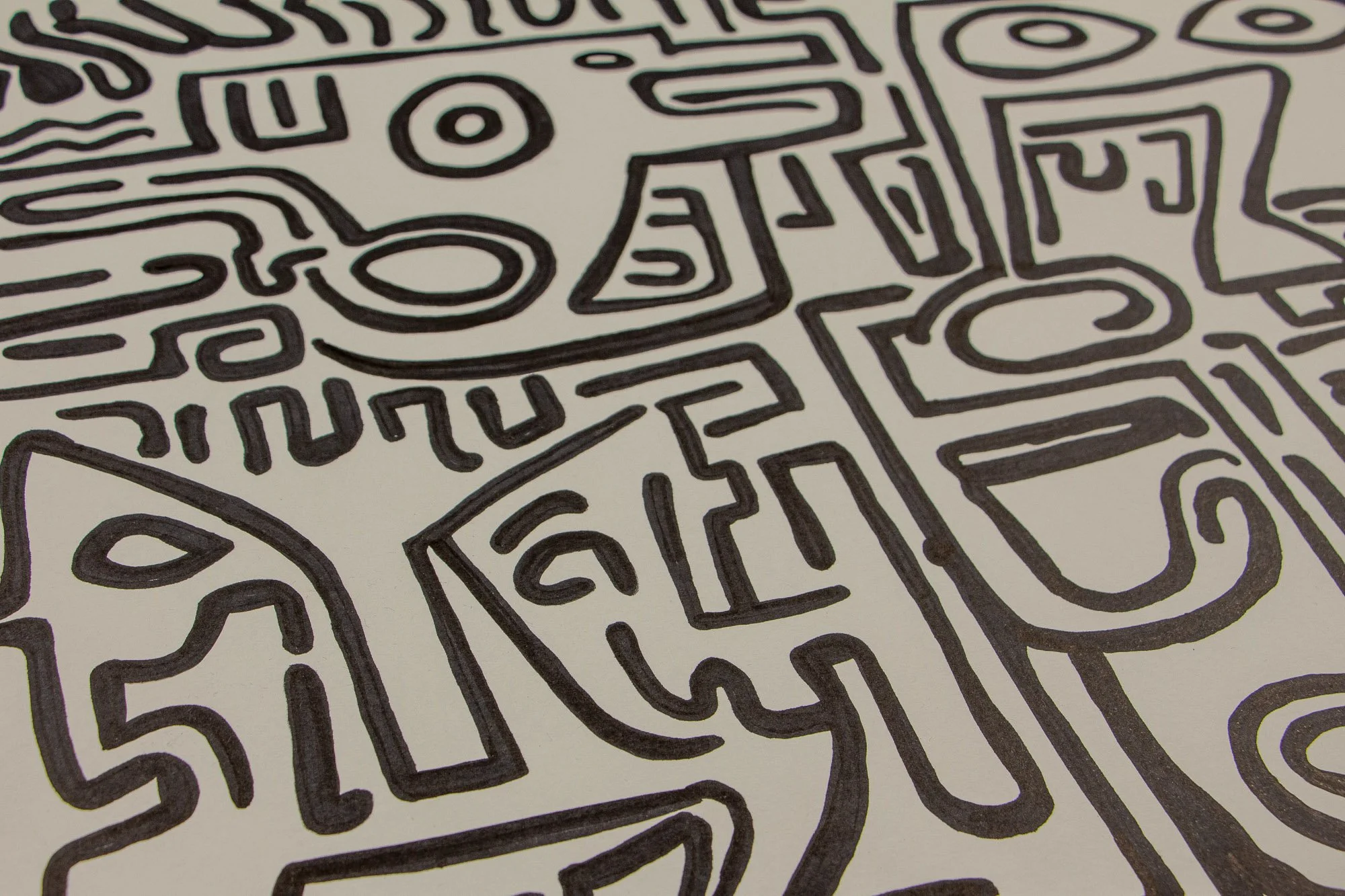 Resonant Syntax 001 detail: angled section with side-profile head, oval mouth, and surrounding maze-like signs; thick black linework across warm white paper